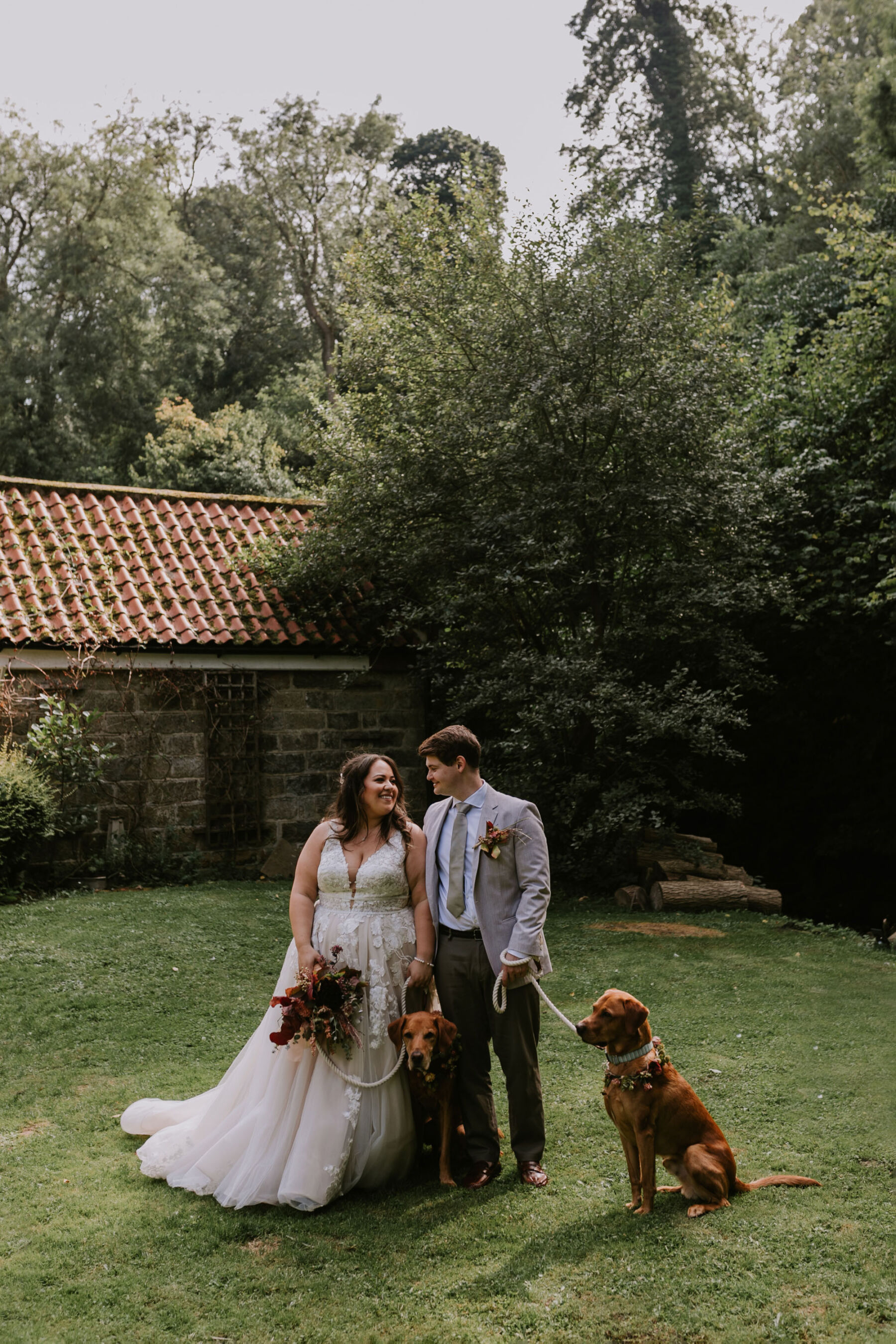 Wedding at Larpool Mill, Whitby. Bride and groom with dog - a Fox Red Labrador.
