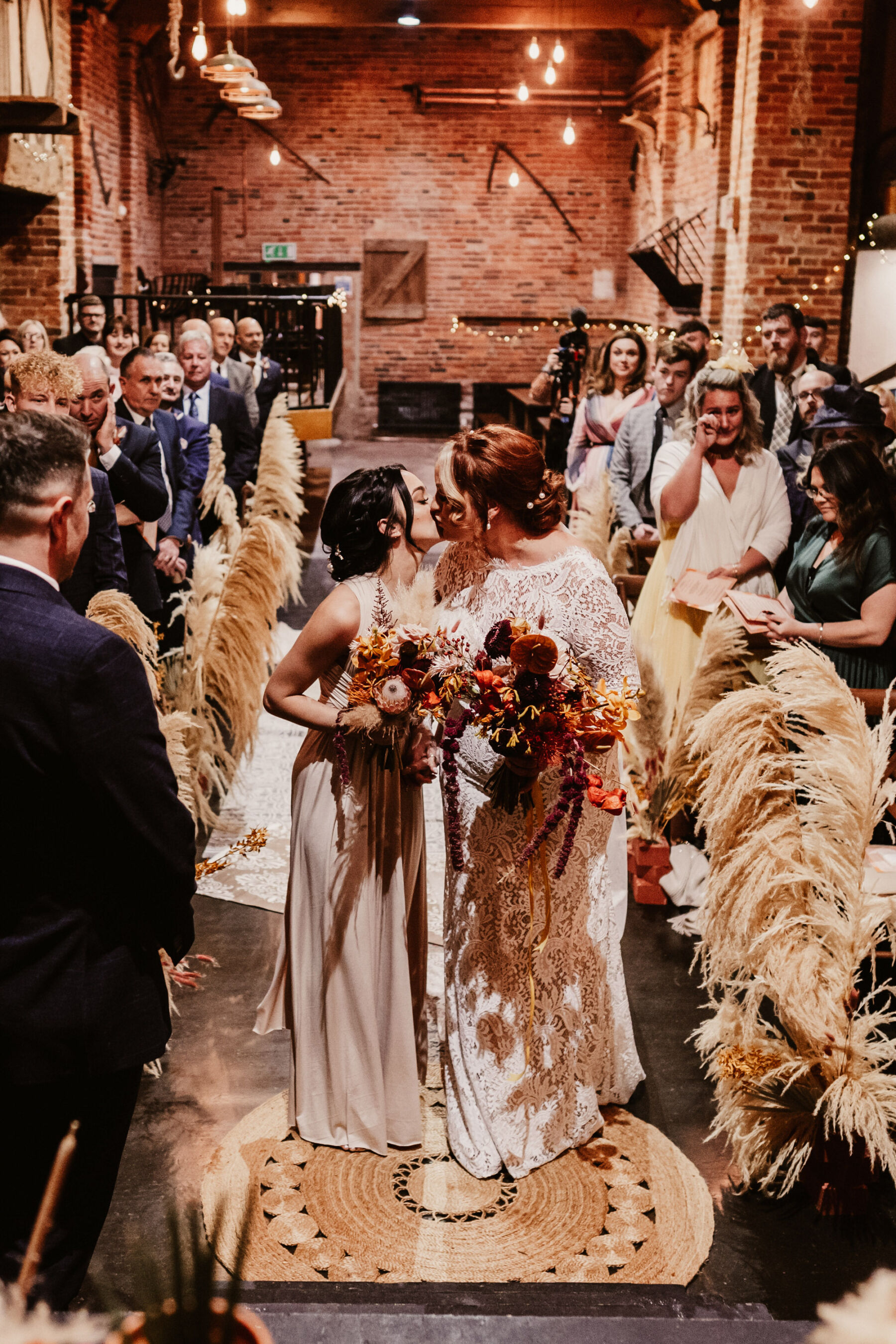 Bride accompanied by her daughter down the aisle.