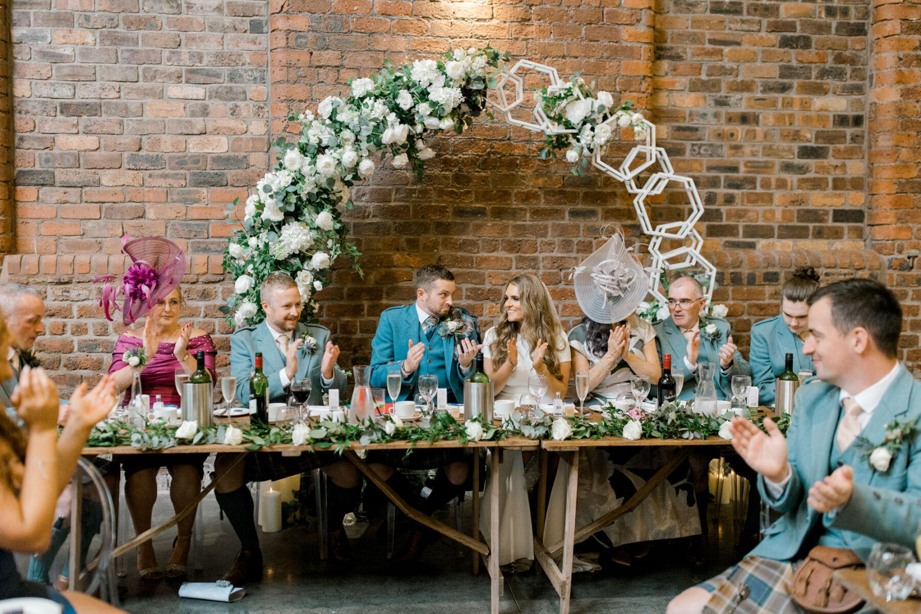 Top table with floral arch behind