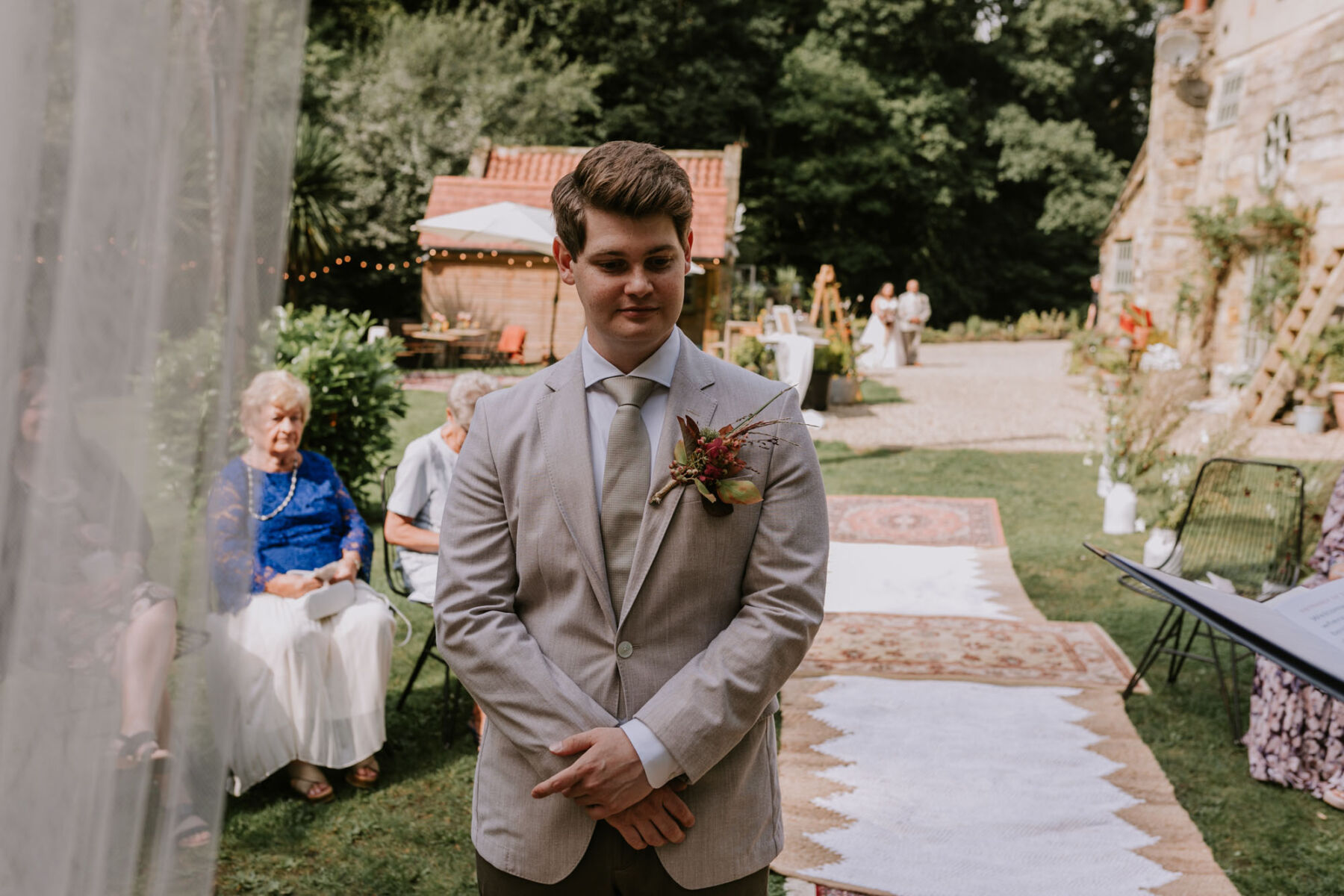 Groom in pale Hugo Boss suit and early Autumn buttonhole. Larpool Mill wedding, Whitby