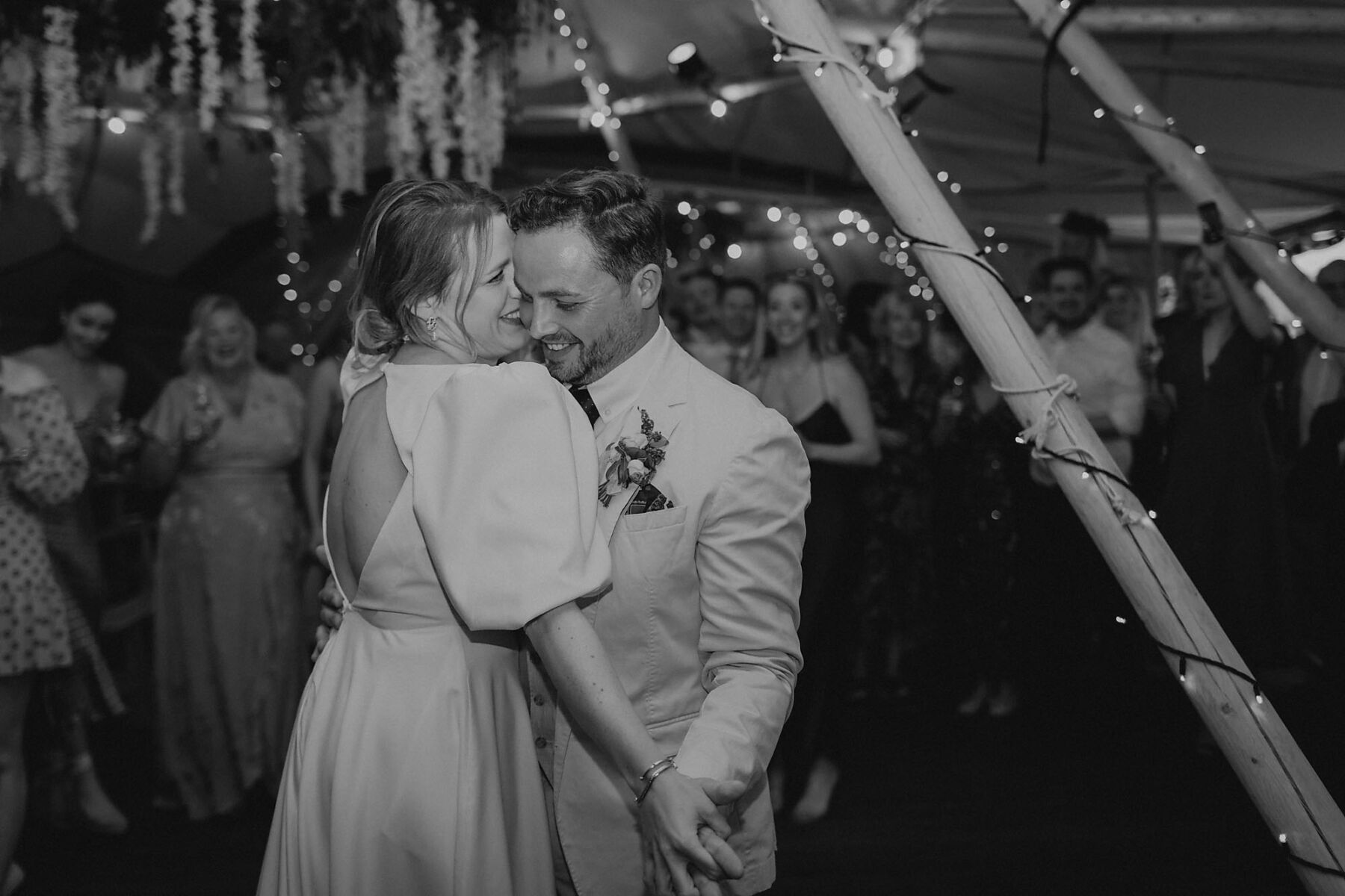 Bride and groom hugging on the dance floor - romantic first dance.