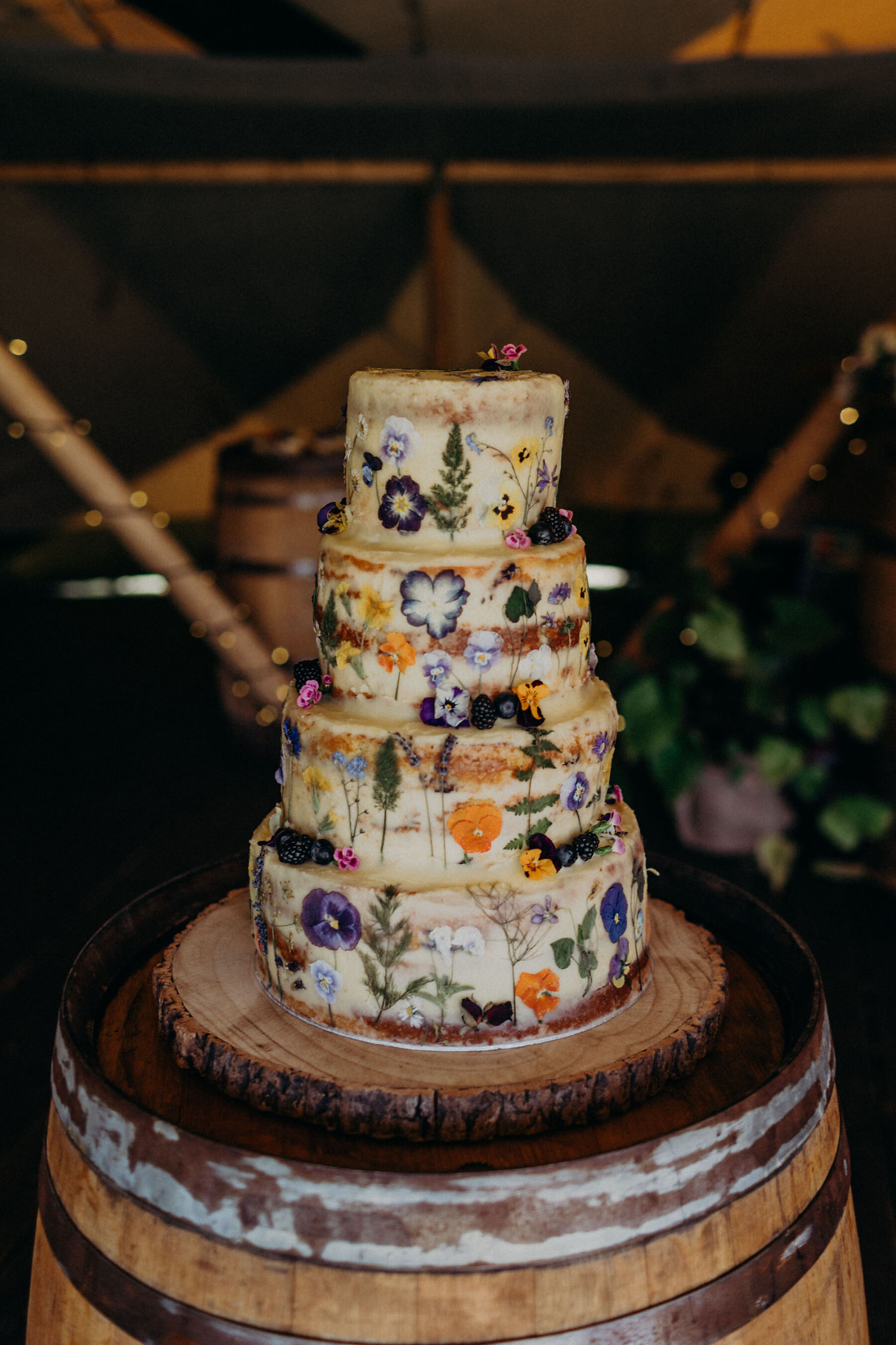 Wedding cake covered in pressed, edible dried flowers.