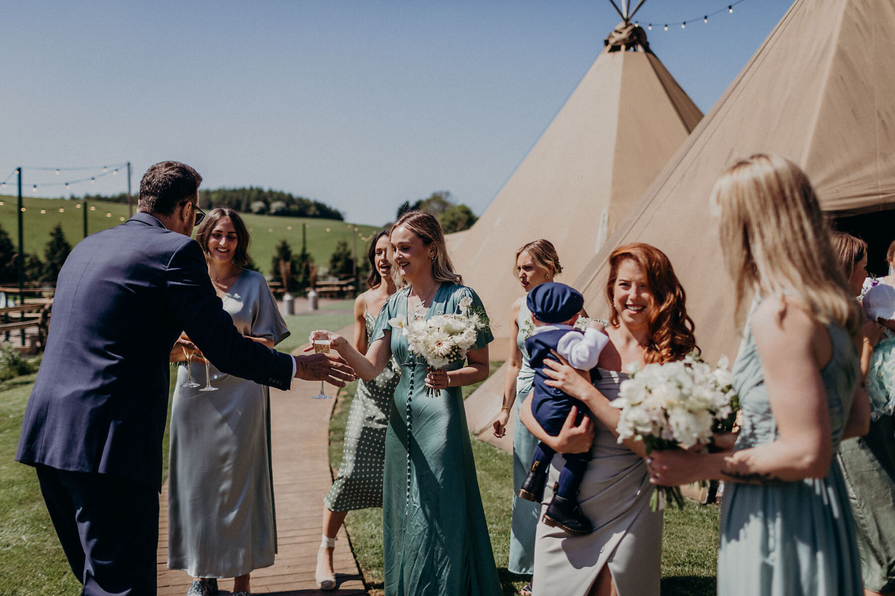 Wedding guests and tipis at Hadsham Farm wedding venue