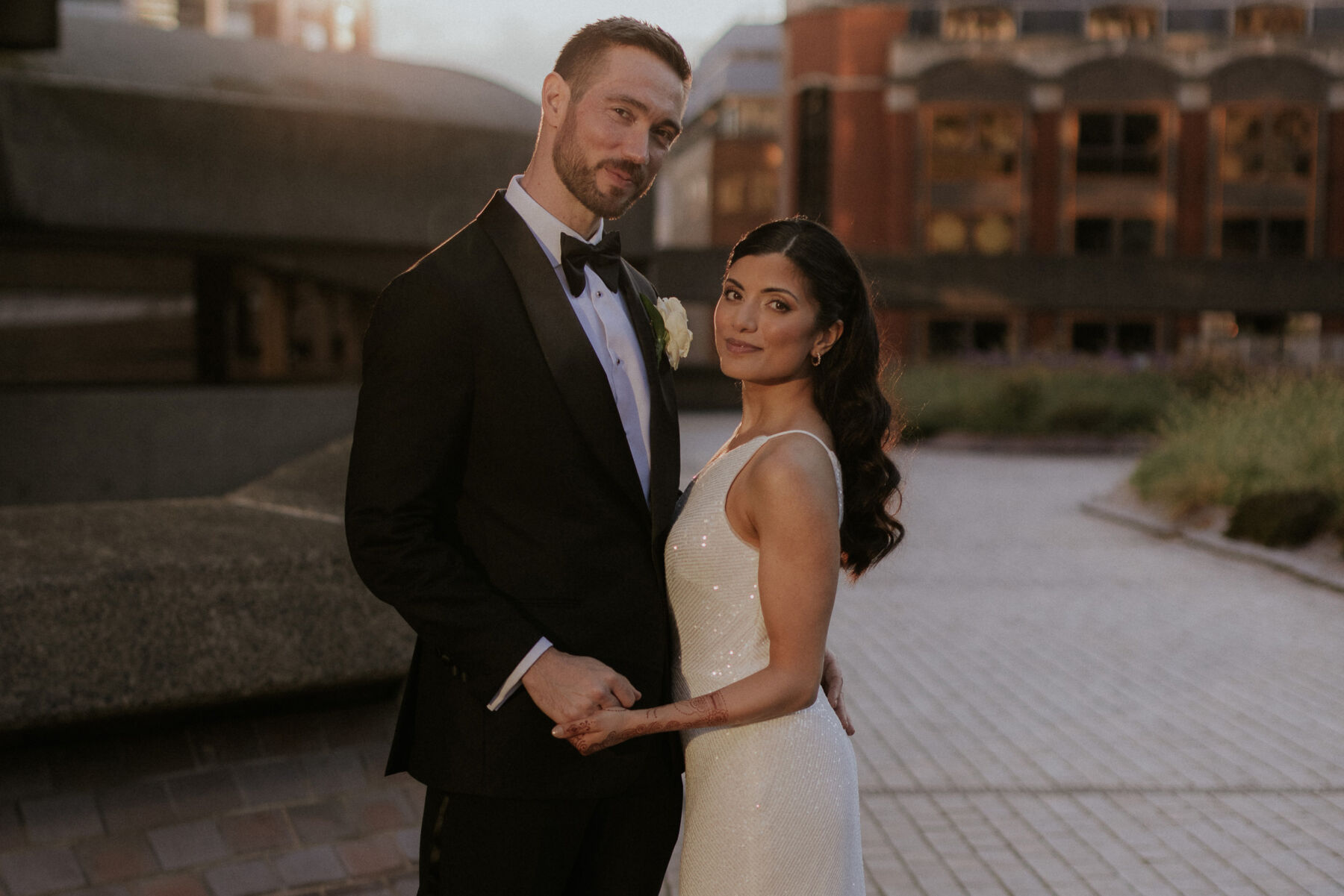 Groom in black tie. Bride in Jenny Yoo wedding dress. London wedding during golden hour.