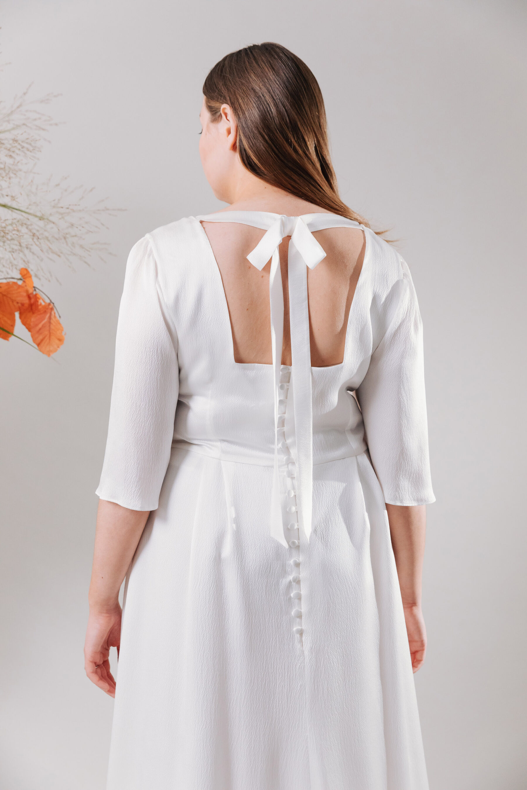 Back of a curvy bride wedding dress by Kate Beaumont