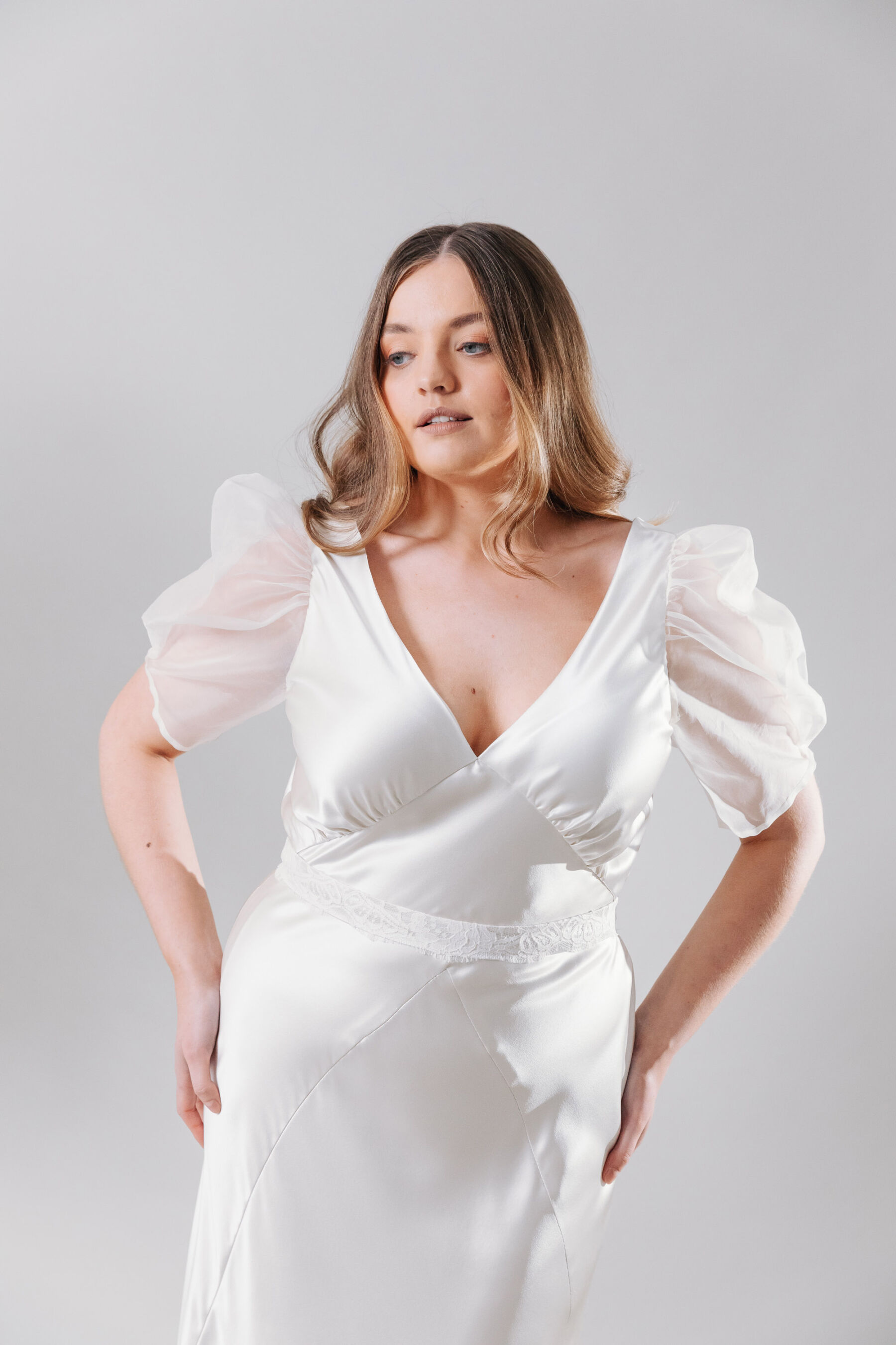 Viola, by Kate Beaumont. Plus size, curvy bride wedding dress with puff sleeves.