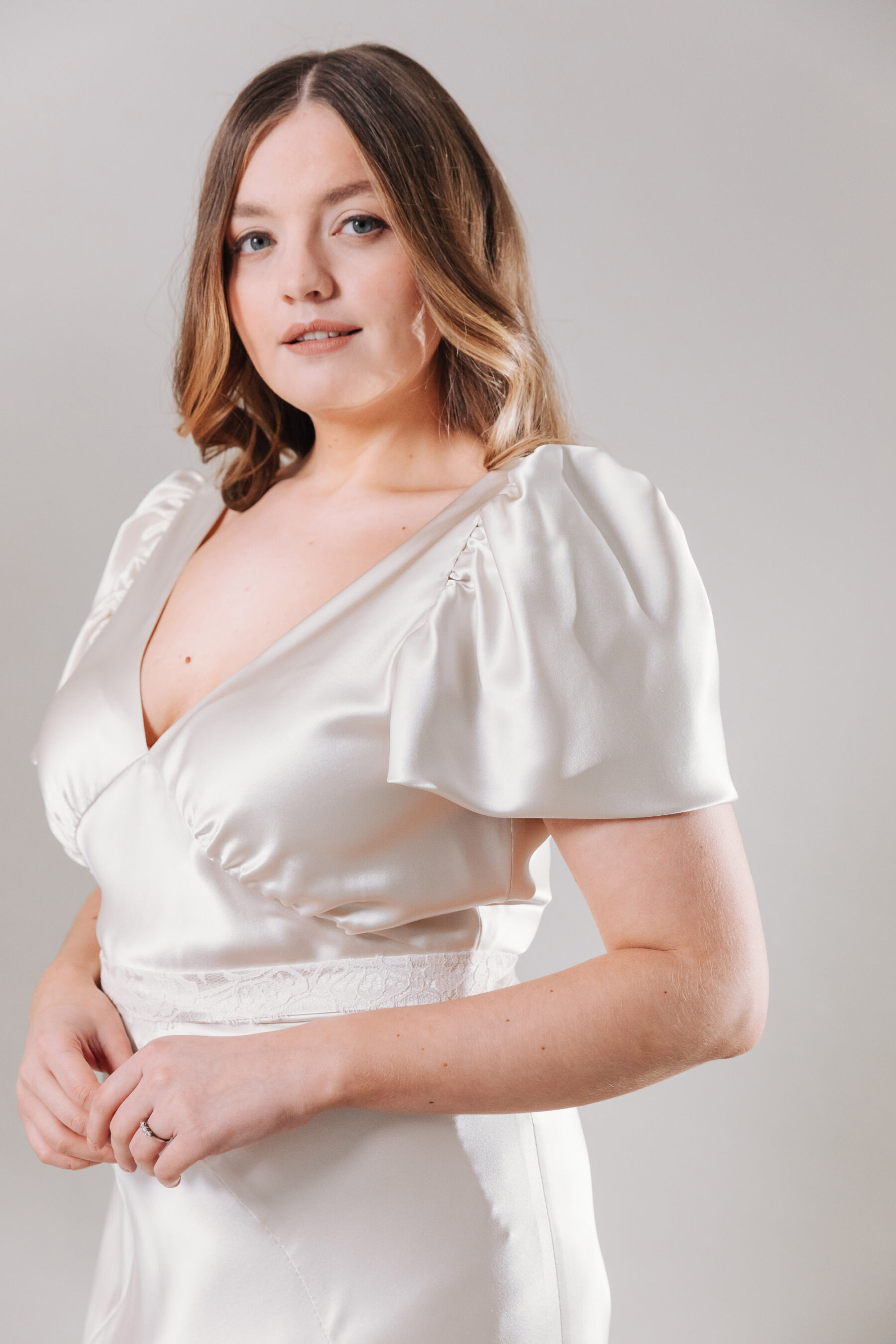 Viola, by Kate Beaumont. Plus size, curvy bride wedding dress with puff sleeves.