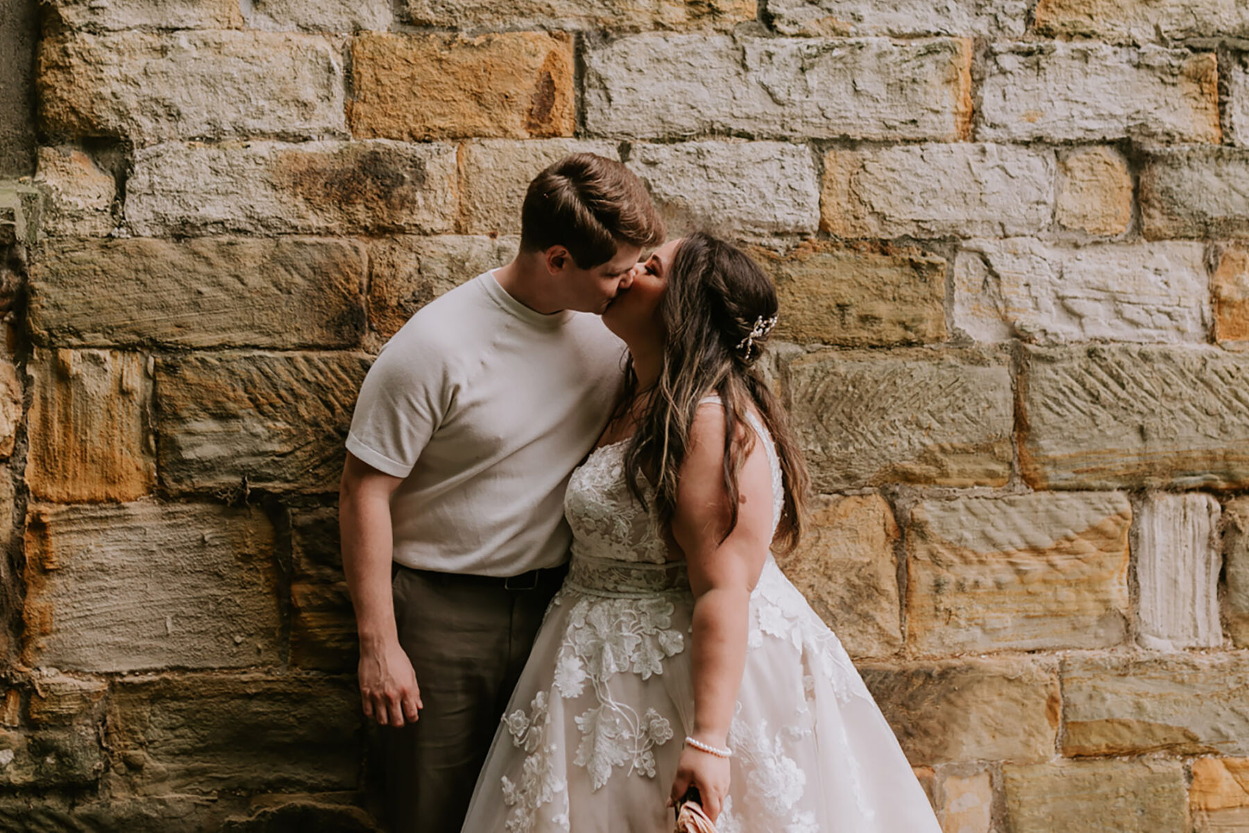 Laid back bride and groom kissing