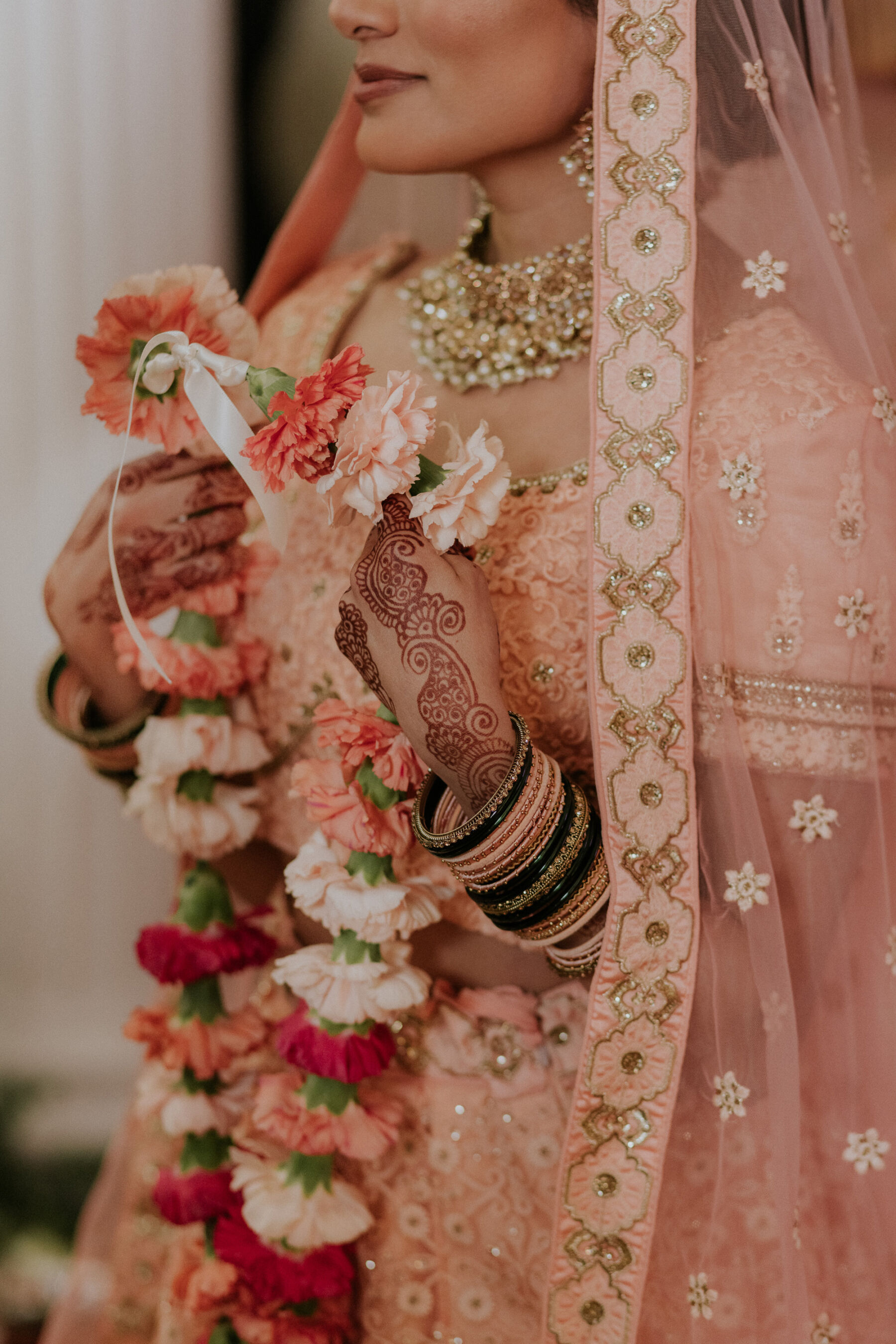Bride in pink lehenga with Mehendi henna tattoo