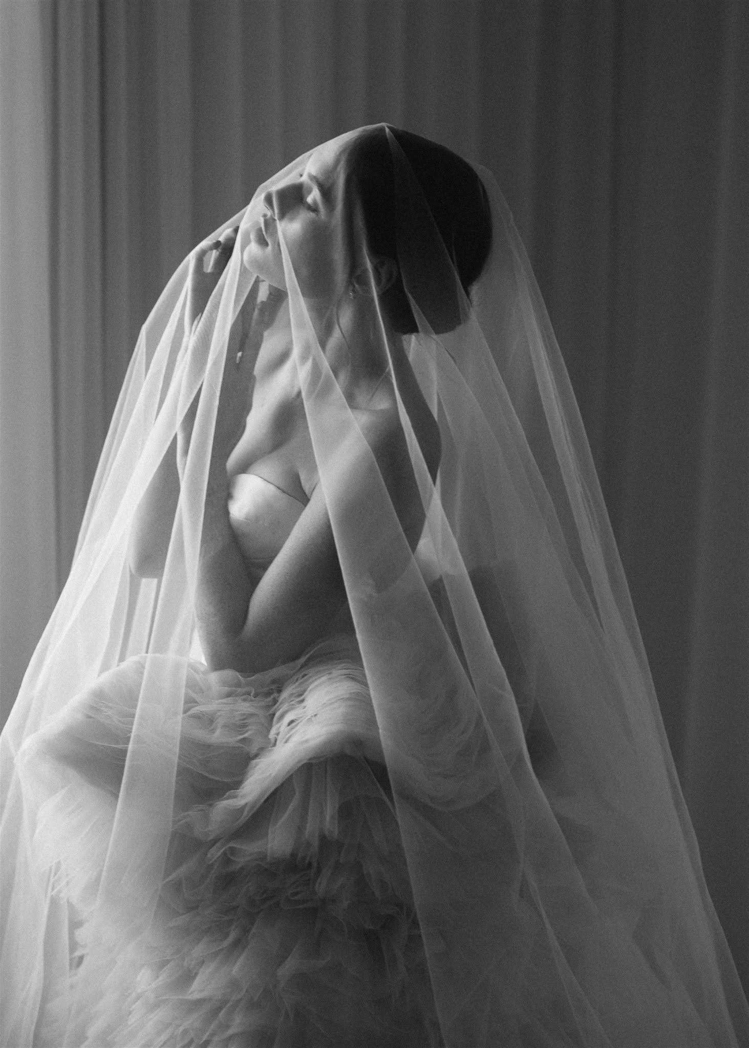Ethereal image of bride beneath a veil wearing a Sally Bean Couture luxury wedding dress. Emilie White Photography.