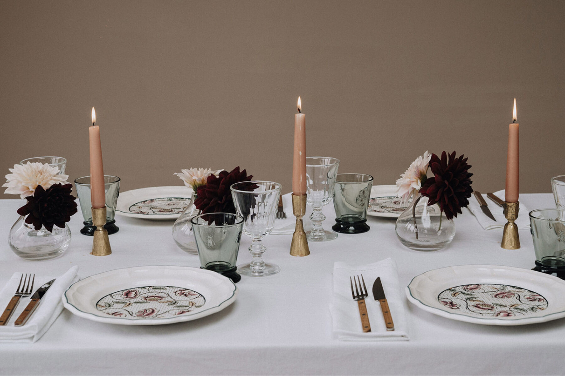 The Wedding Present Company - Elegant modern table setting with taper candles, brass candle stick holders and contemporary glassware.