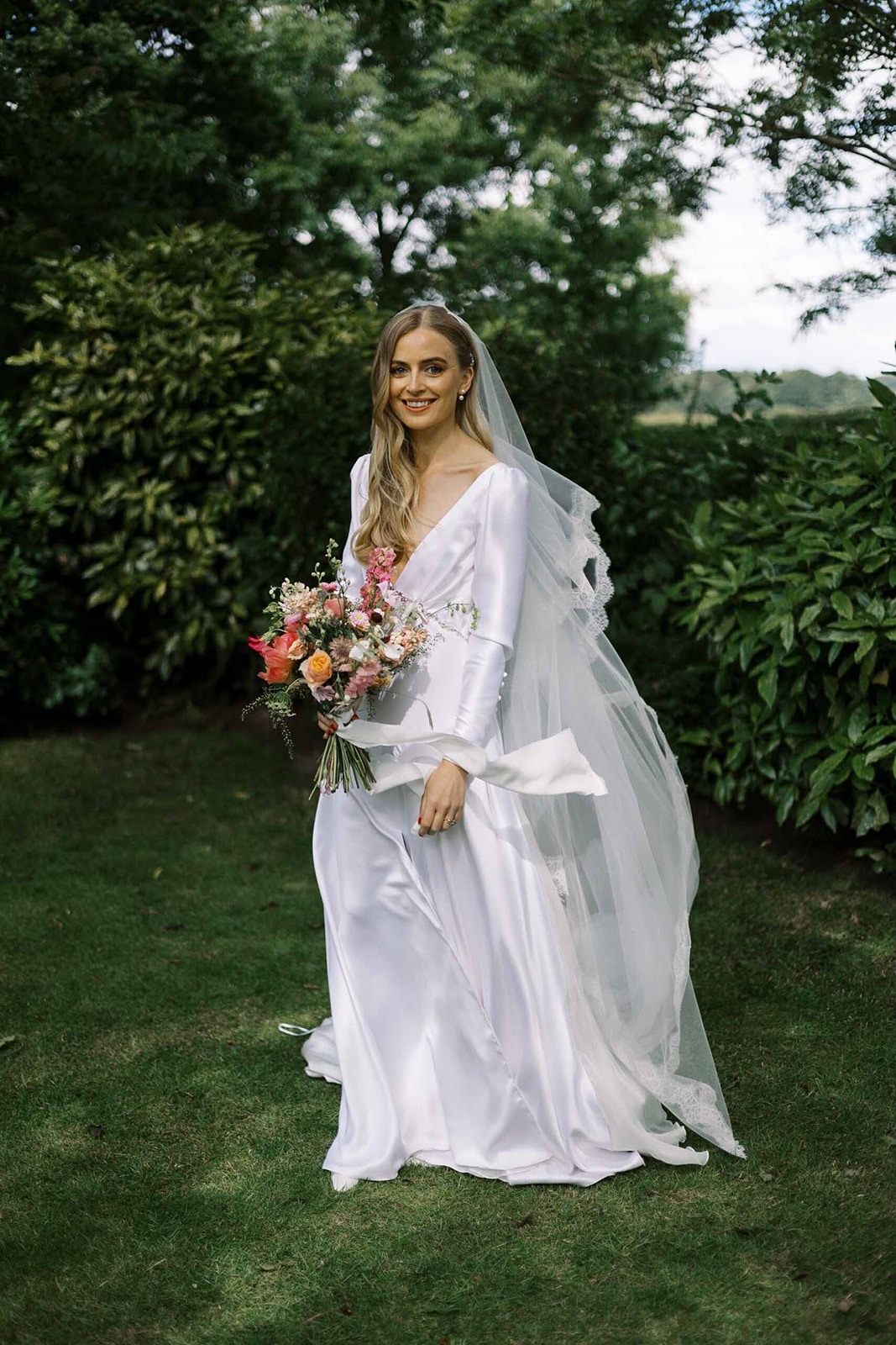 Bride wearing an elegant bias cut wedding dress by Wilden London. Image by Emmy Shoots Photography.