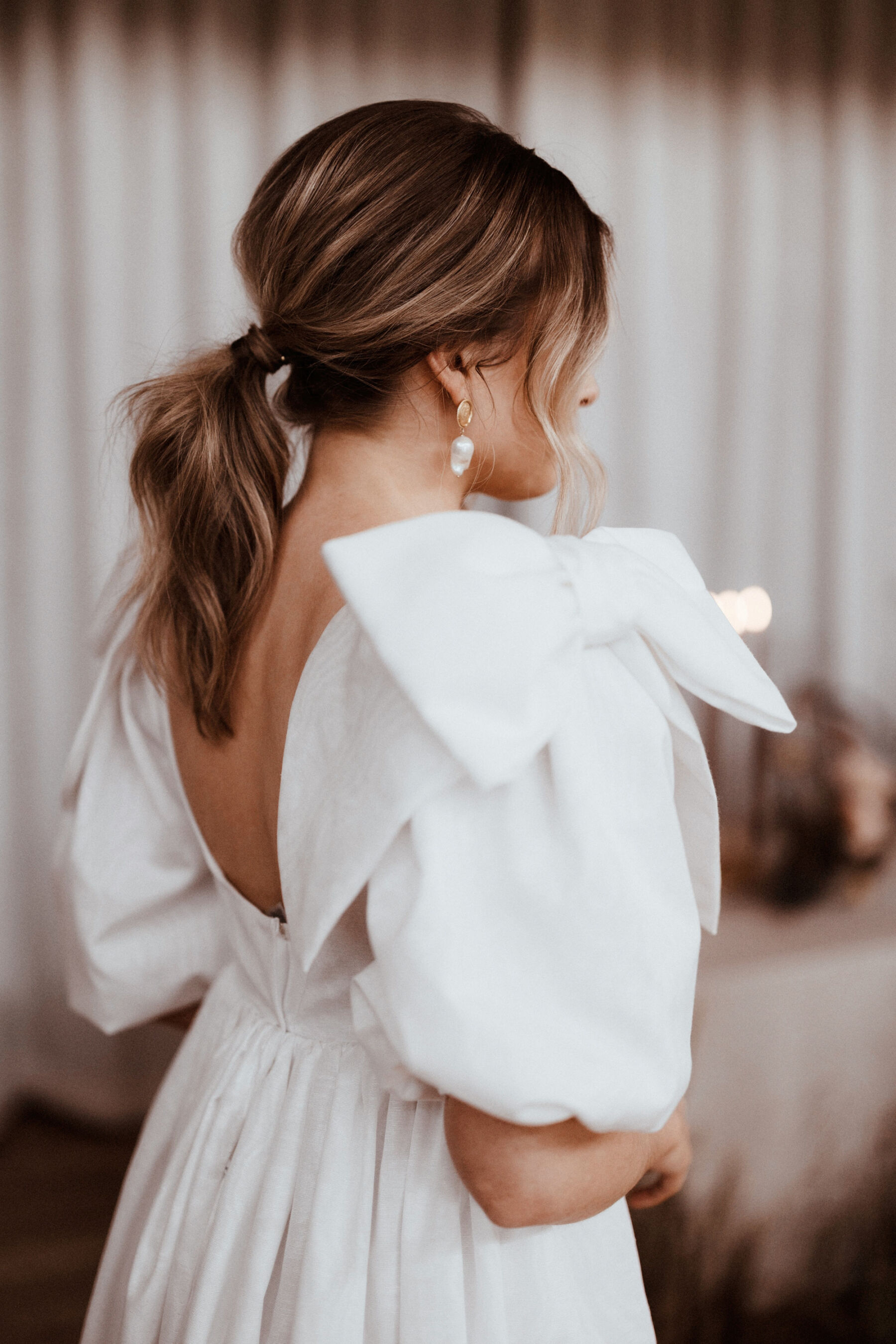 Introducing Wilden London, Romantic, Bespoke and Made to Measure Wedding Dresses 8 Real bride wearing a Wilden London wedding dress with oversized bows on the shoulders. Image by Rebecca Rees Photography.