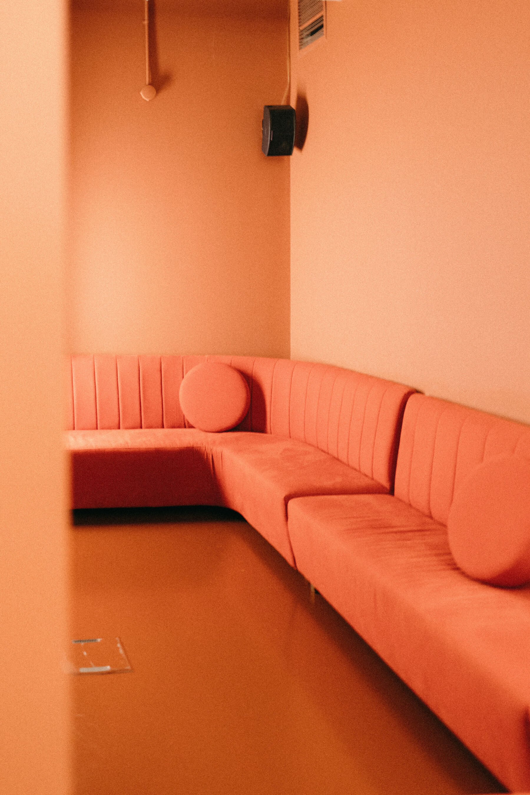 Modern orange sofa. Rebecca Rees Photography.