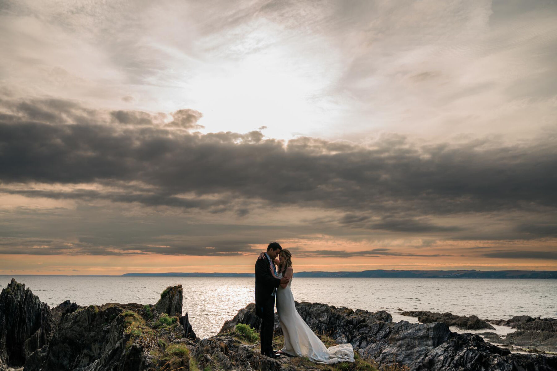 Bride and groom on the private beach at Polhawn Fort, Cornwall.