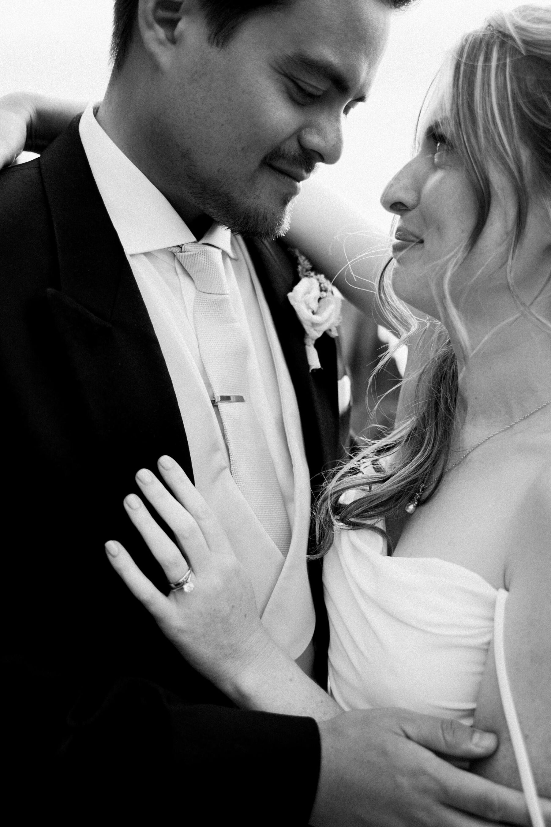 Black and white shot of bride and groom in loving embrace