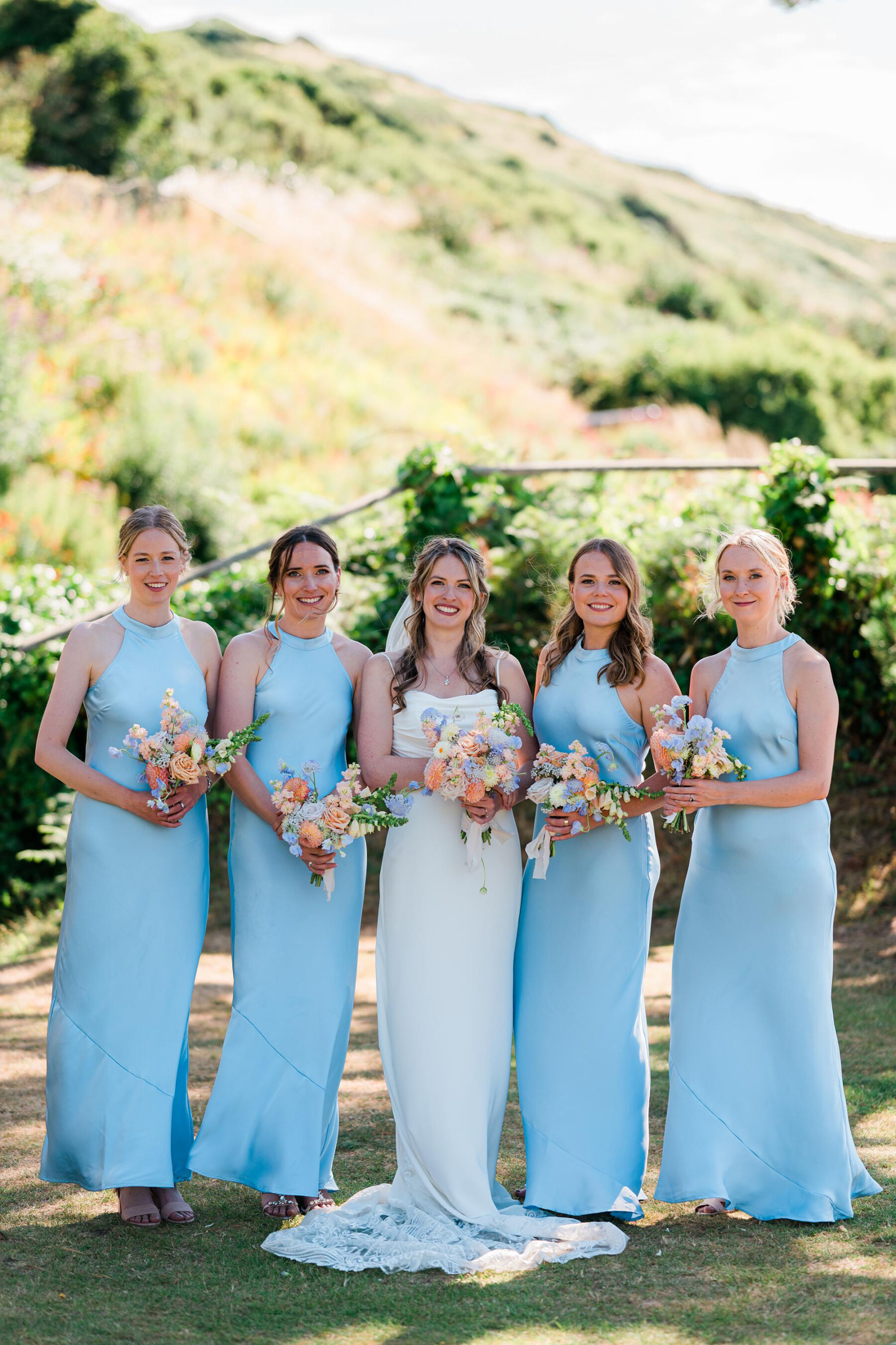 Bridesmaids in satin blue halterneck dresses
