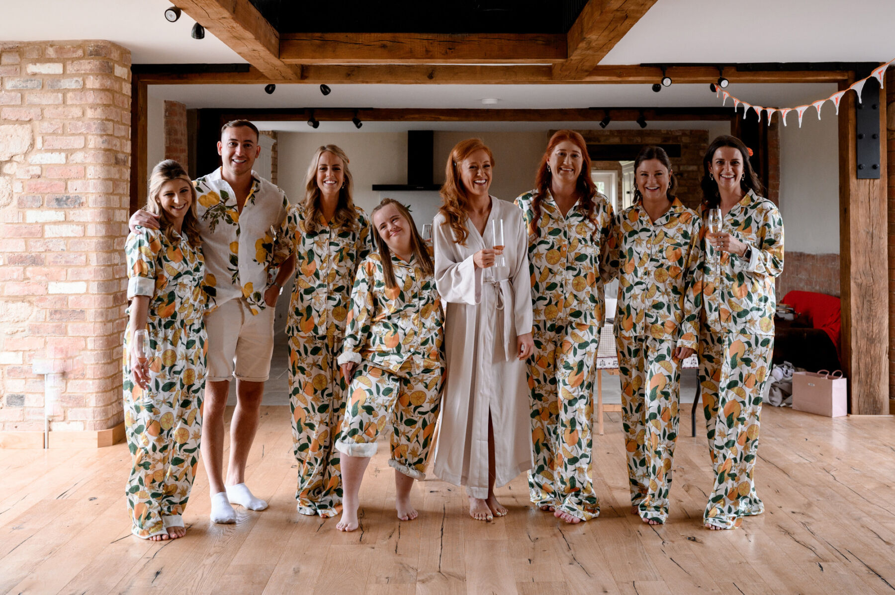 Bridesmaids in lemon pyjamas getting read with bride. Taylor Hughes Photography.