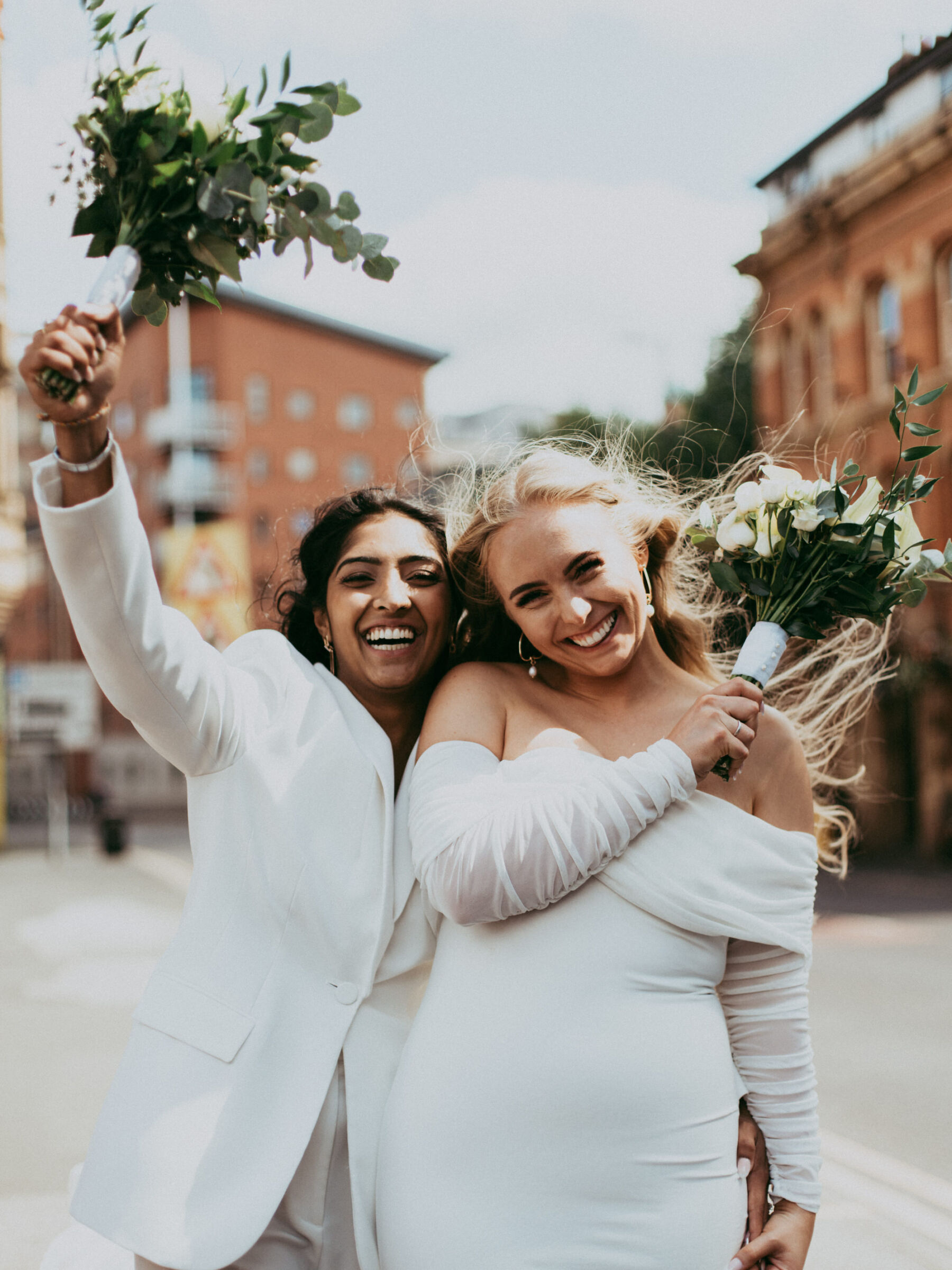 Same sex wedding. Lesbian bride in short dress. Lesbian bride in suit.  Daniel Mice Photography.