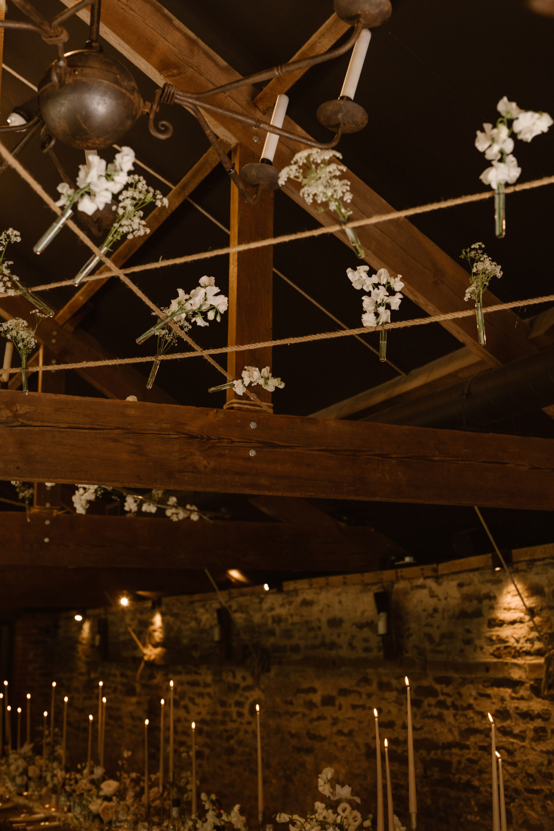 Flowers hanging from the barn ceiling at Dewsall Court. Agnes Black Photography.