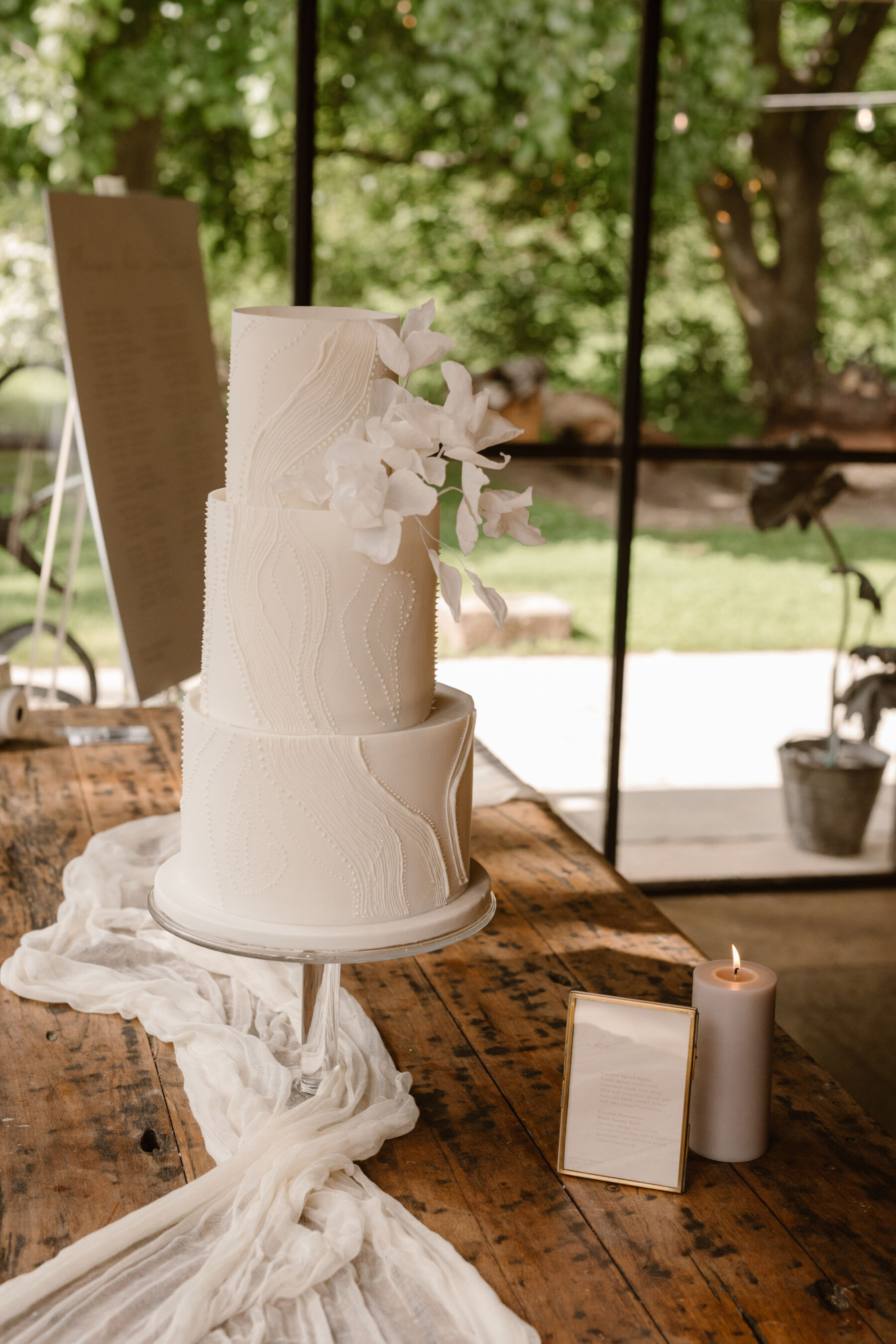A Look Inside Dewsall Court Country House, A Family Run Wedding Venue in Herefordshire 30 3 tier white wedding cake with iced orchids by Marble Cake Company. Agnes Black Photography.