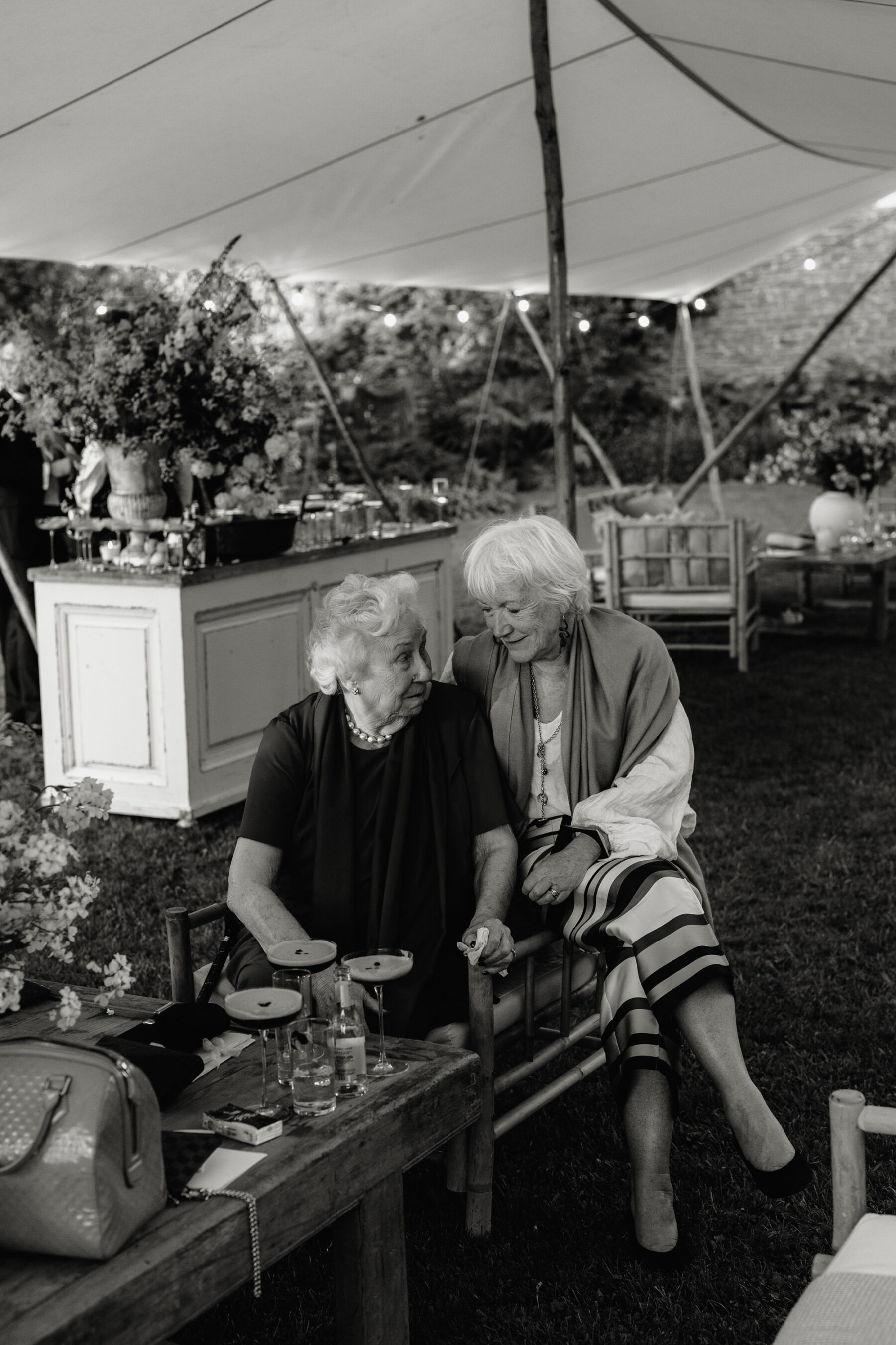 Two elderly wedding guests at at wedding at Dewsall Court. Agnes Black Photography.