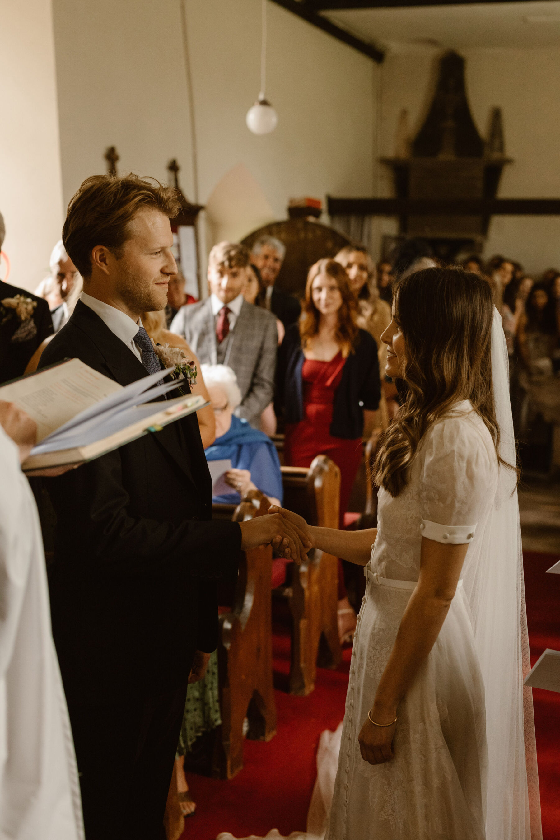 Jess in J. Andreatta for her Elegant Weekend Wedding at Dewsall Court 17 Wedding at Dewsall church, Herefordshire. Agnes Black Photography.
