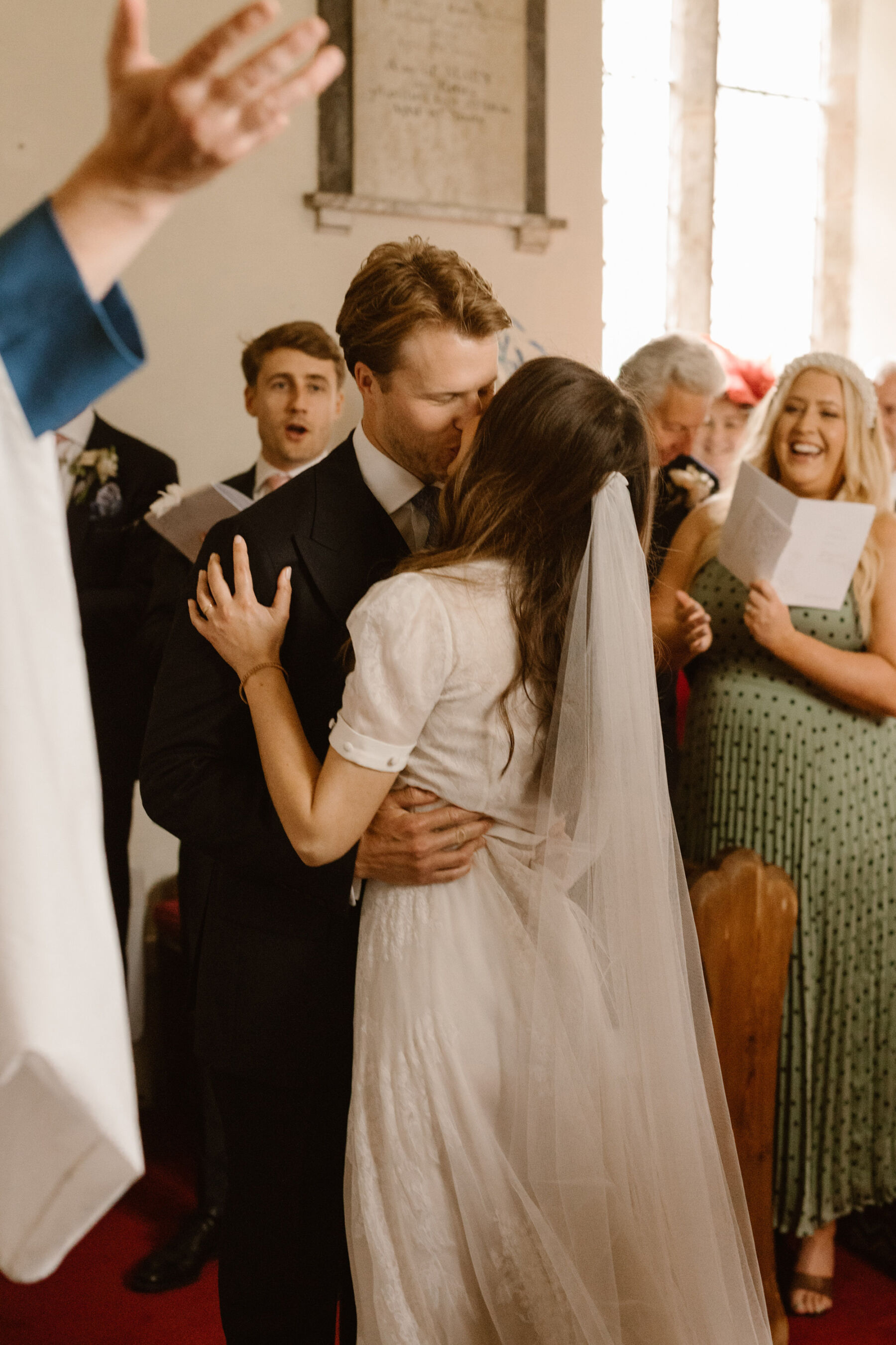 Bride and groom kissing in church. Agnes Black Photography.