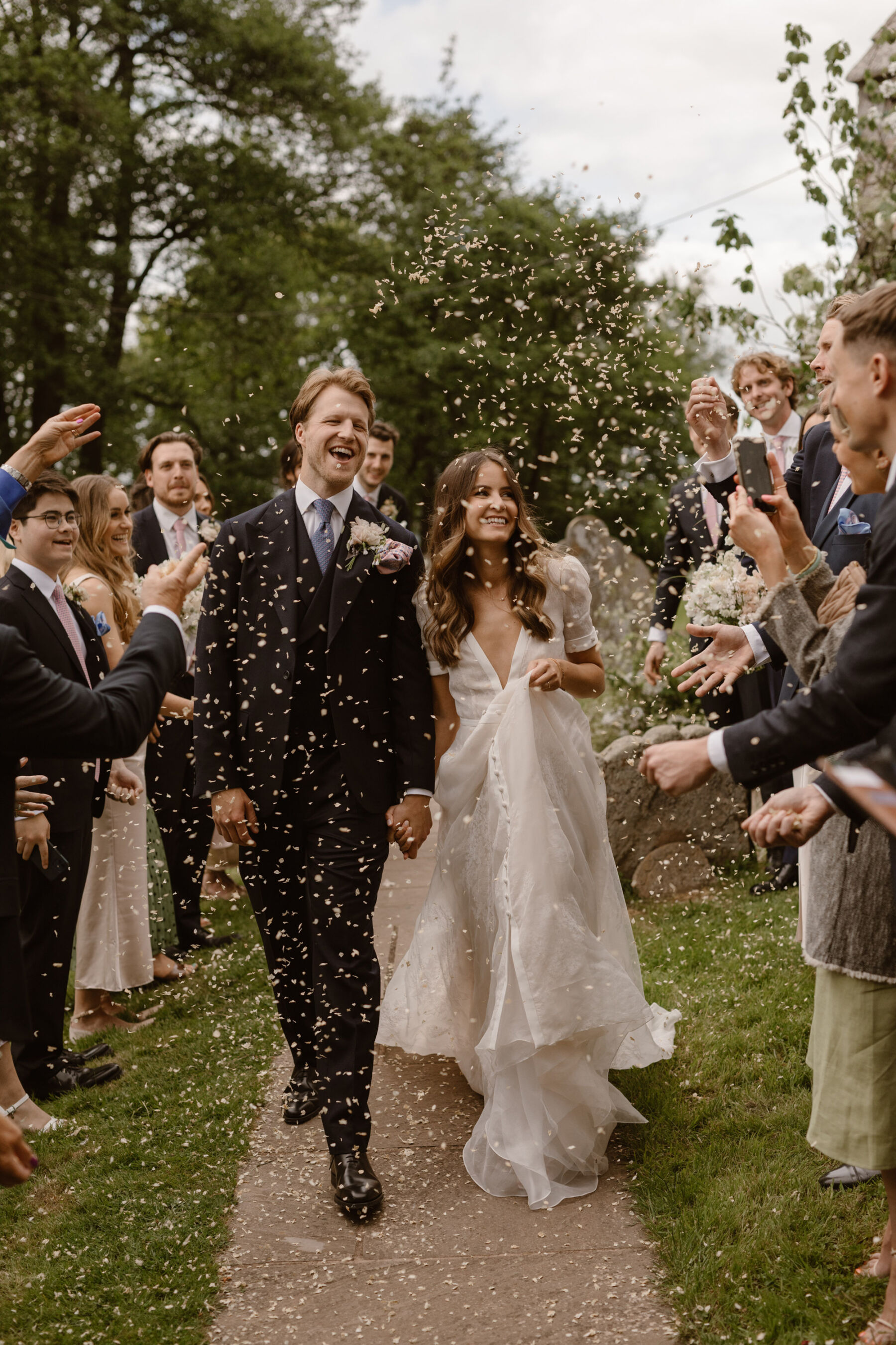 Confetti shower. Bride wears J Andreatta gown. Dewsall Court wedding. Agnes Black Photograpy.