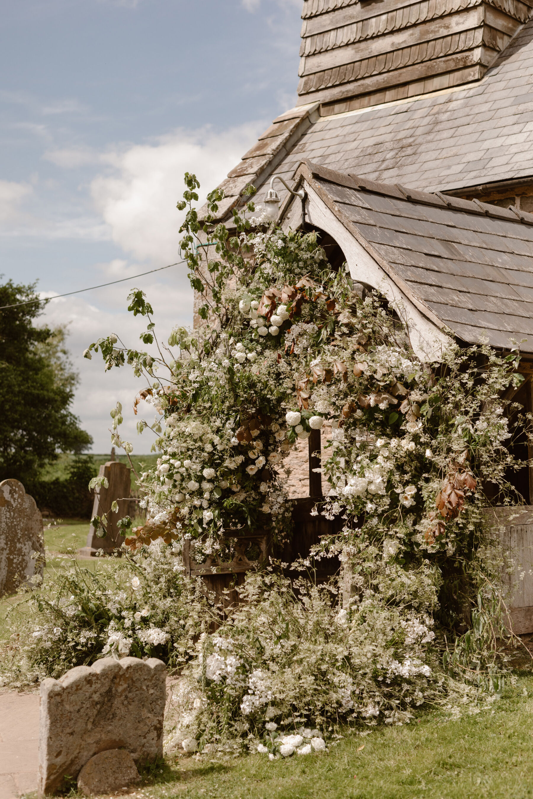 Church door surrounded by natural arch by Liberty Lane Flowers. Agnes Black Photography.