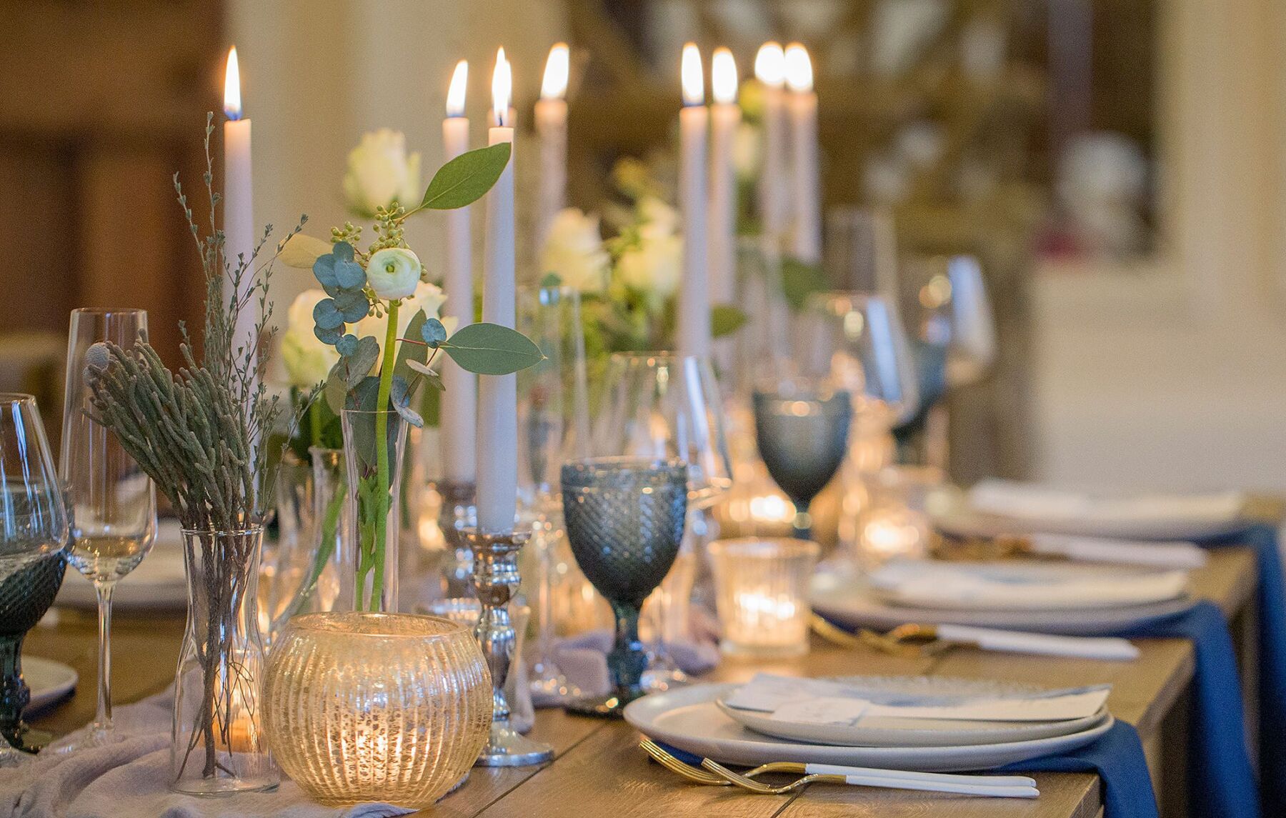 Eucalyptus Events - Cotswolds Wedding Planner. Elegant blue wedding table with pale grey tapered candles.