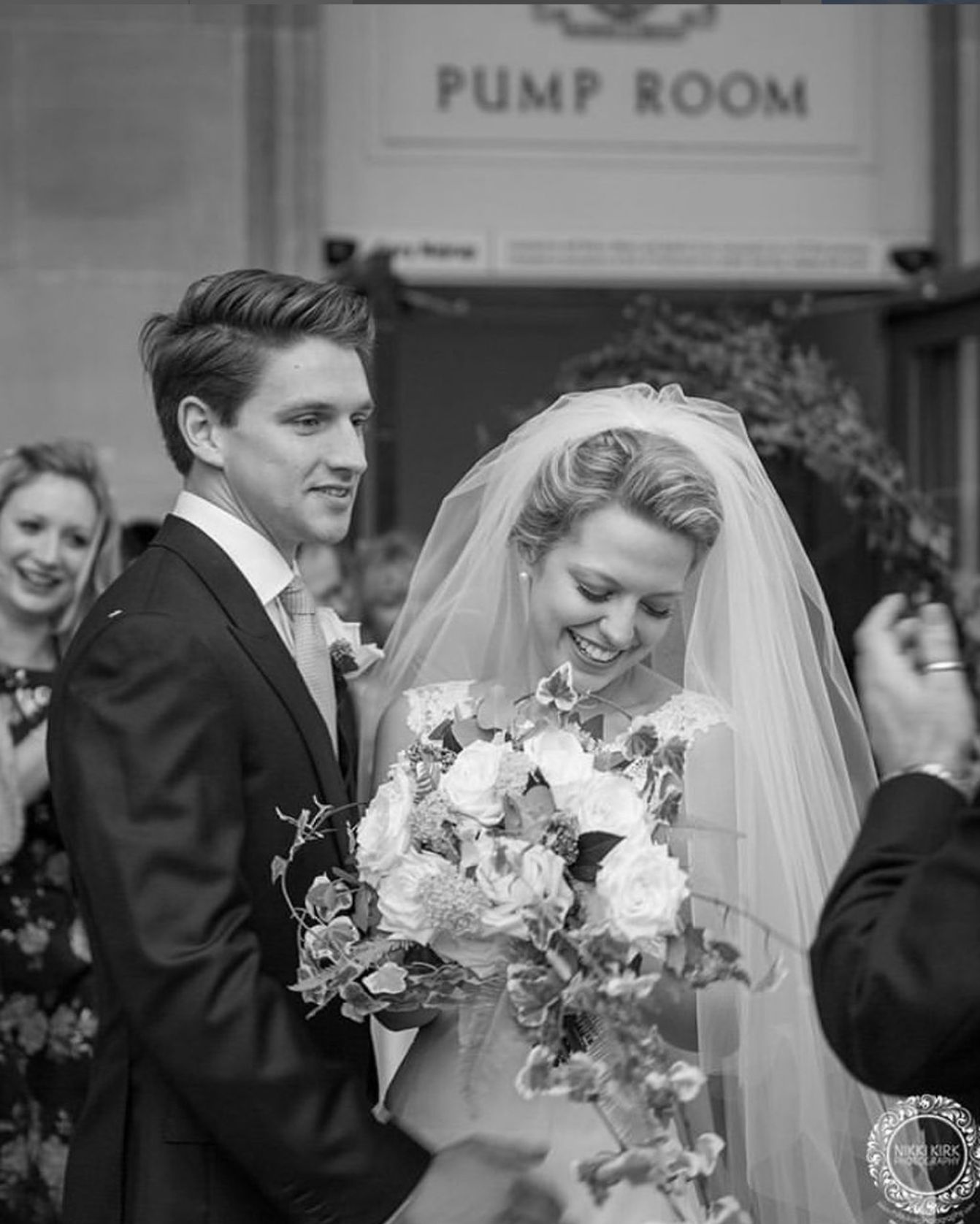 Tender black and white photograph of bride and groom just married.