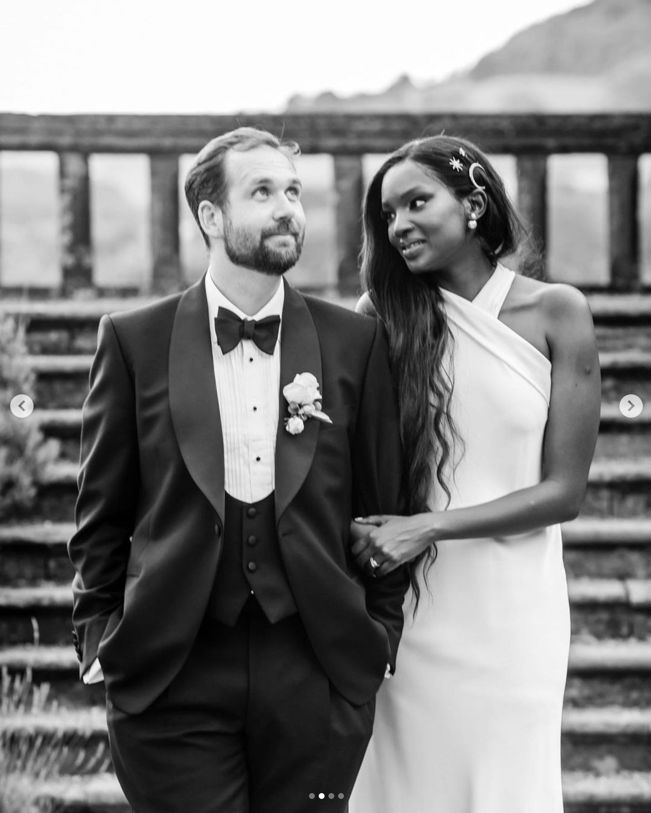Eucalyptus Events, Cotswolds Wedding Planner - classy wedding photography of mixed race bride and groom - black bride in halterneck wedding dress hugging white groom in black tie.