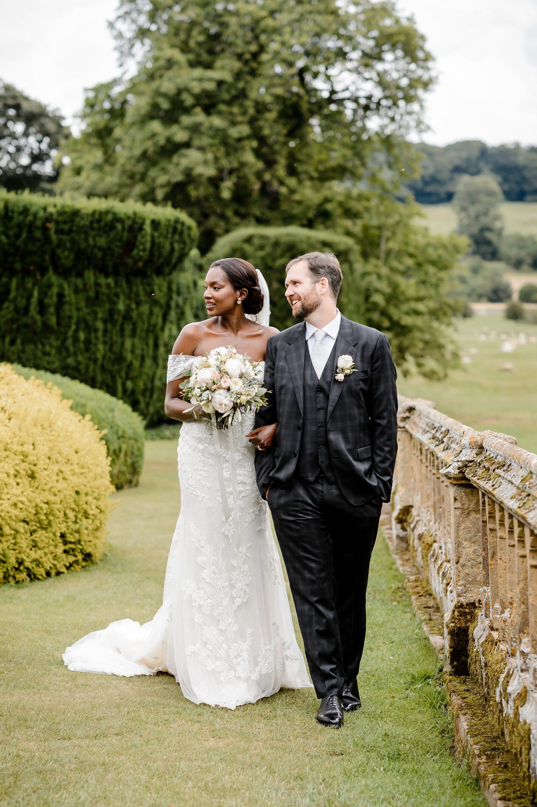 Eucalyptus Events, Cotswolds Wedding Planner - mixed race bride and groom. Beautiful black bride in off the shoulder dress and groom in checked suit.