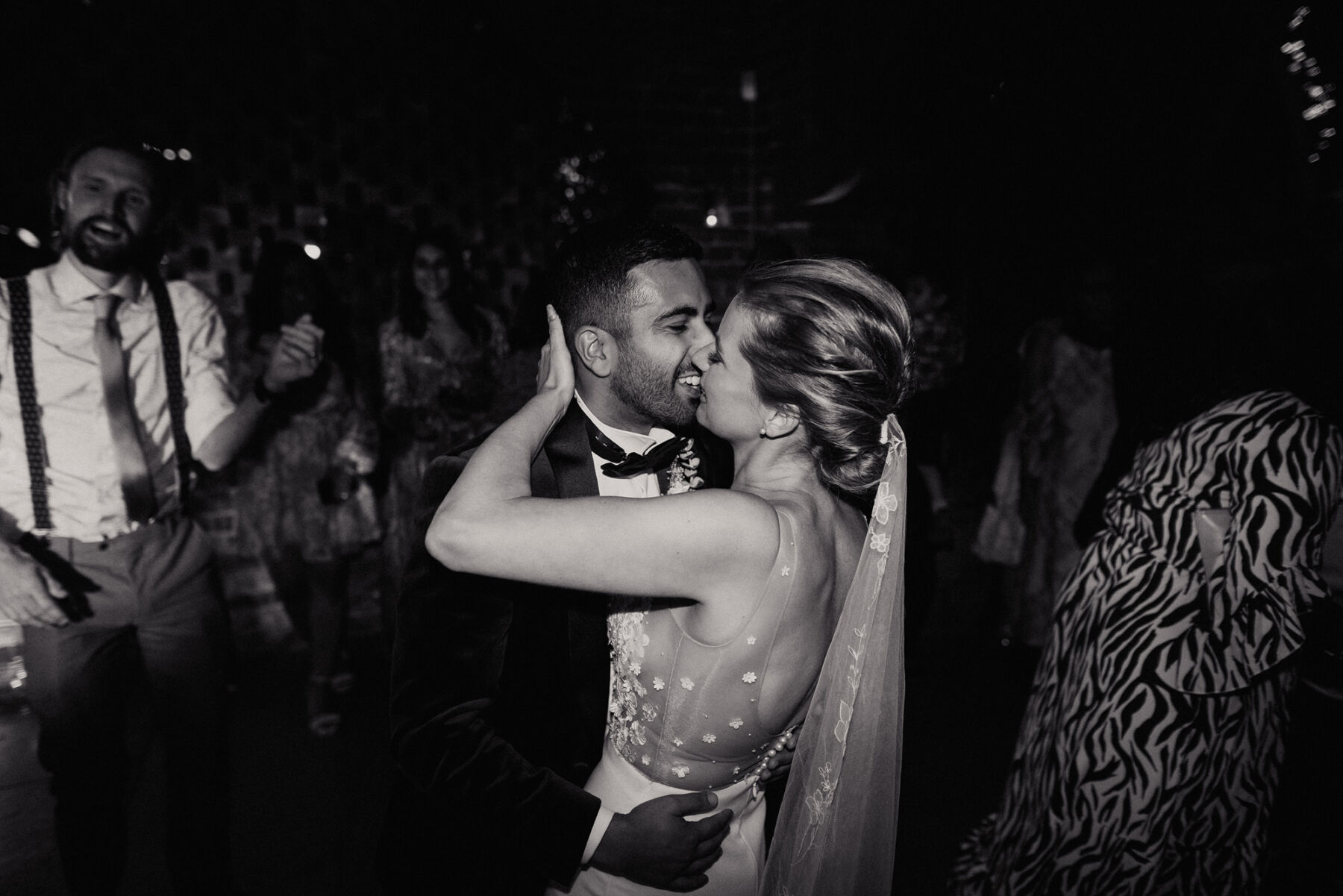 Glamorous bride and groom kissing on the dance floor