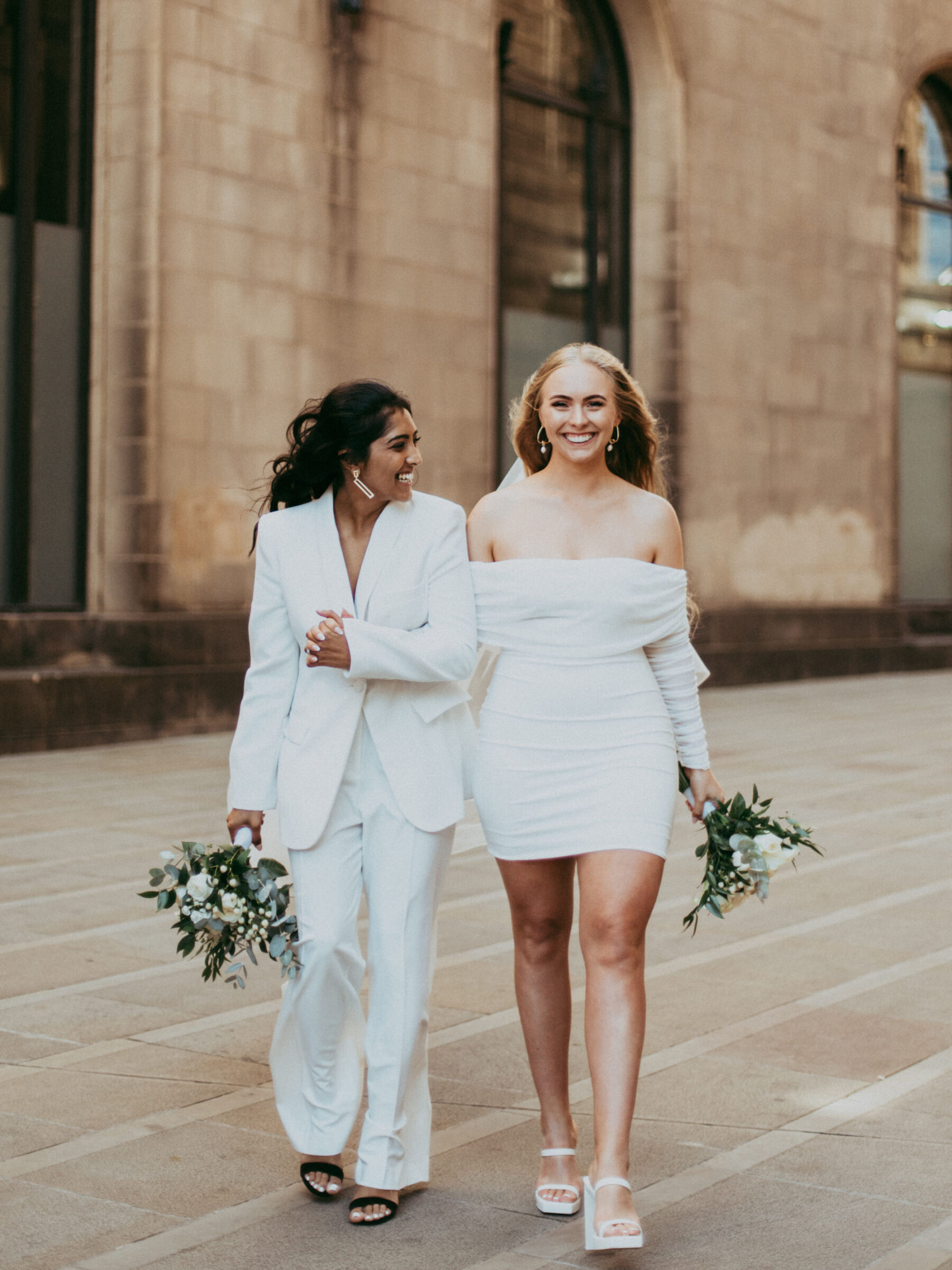 Lesbian wedding with Lesbian brides holding hands. Daniel Mice Photography.