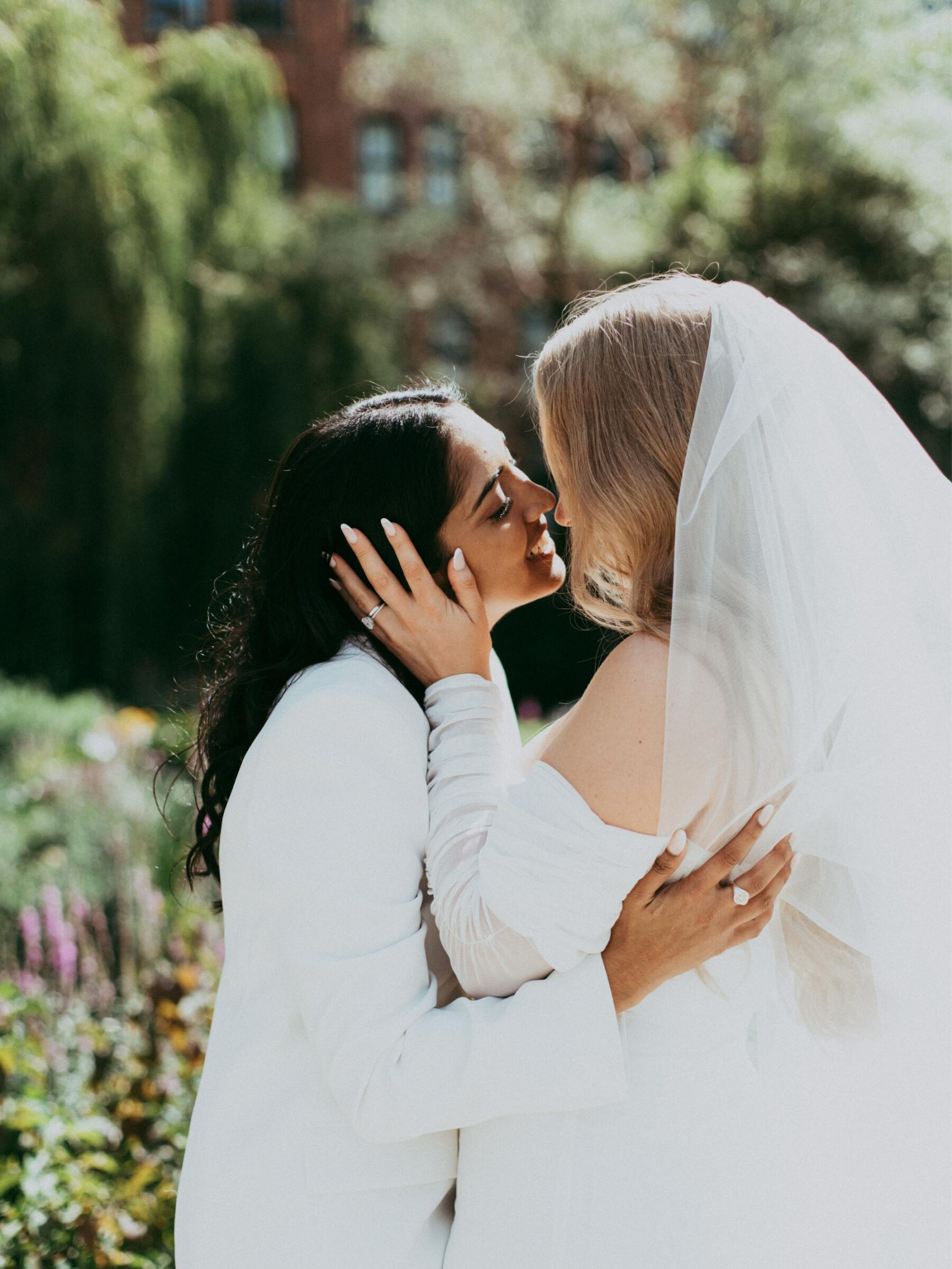 Lesbian brides in a tender embrace. Daniel Mice Photography.