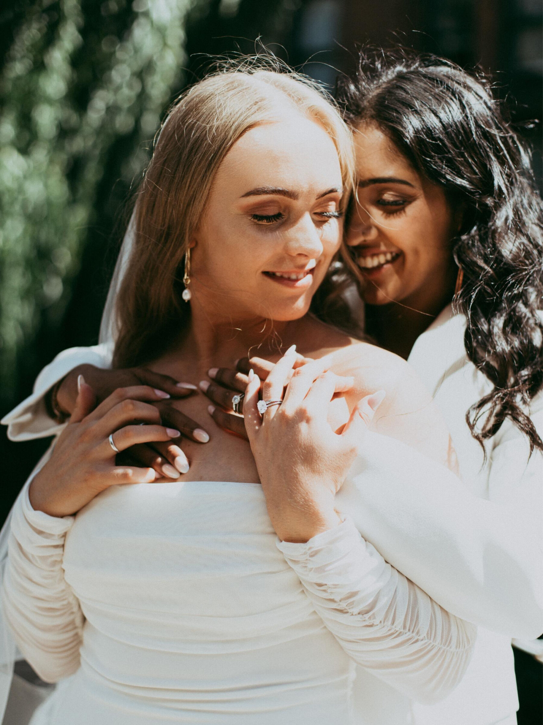 Lesbian brides in loving embrace. Daniel Mice Photography.