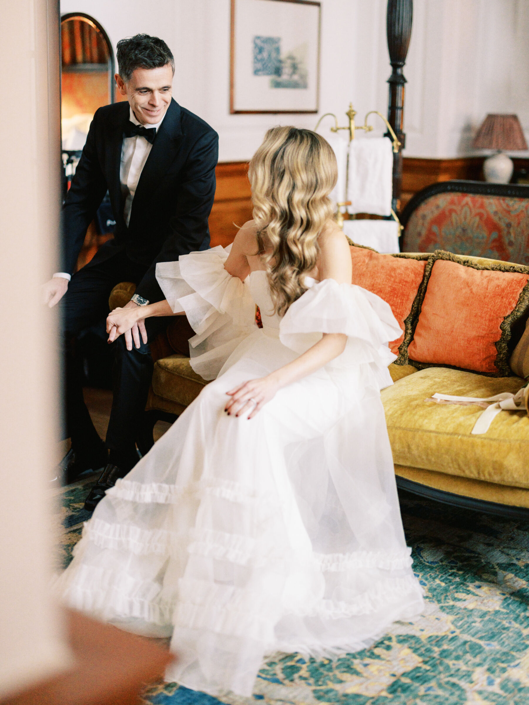Elegant modern bride and groom in black tie, at The Ned, London. Bride has long wavy blonde hair. Kernwell Photography.