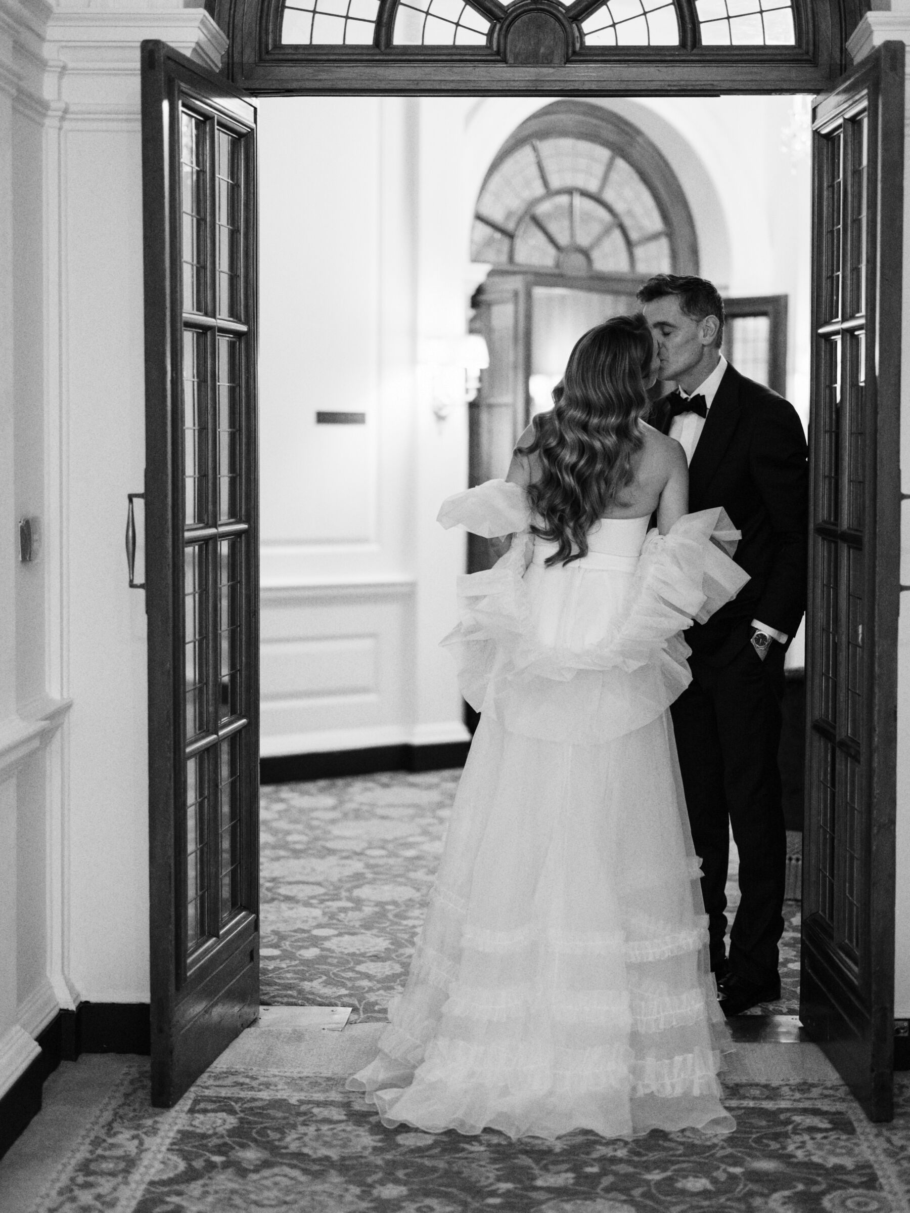 Romantic image of bride and groom kissing inside The Ned, London. Kernwell Photography.