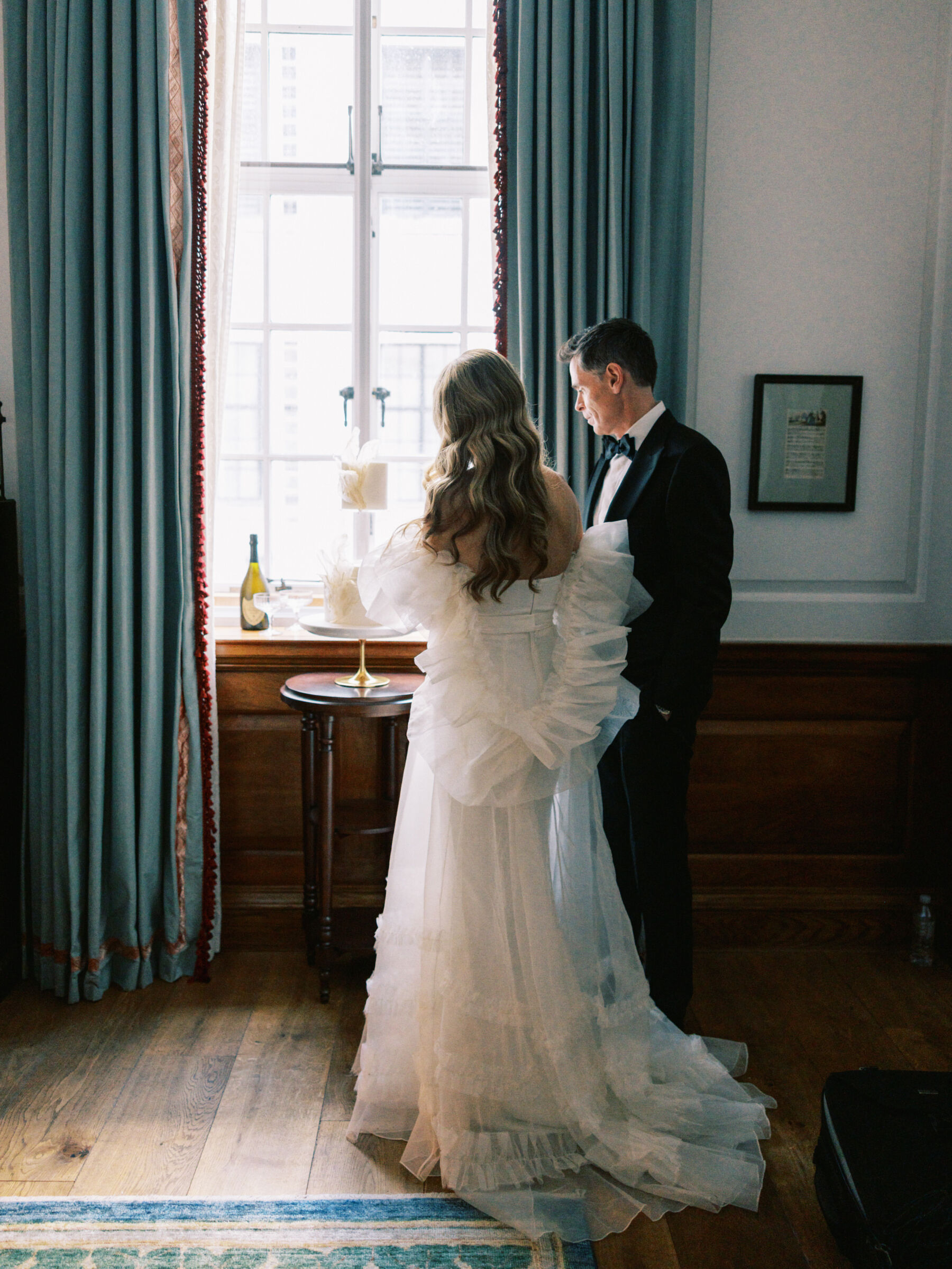 Bride and groom at The Ned, London and drinking champagne. Kernwell Photography.
