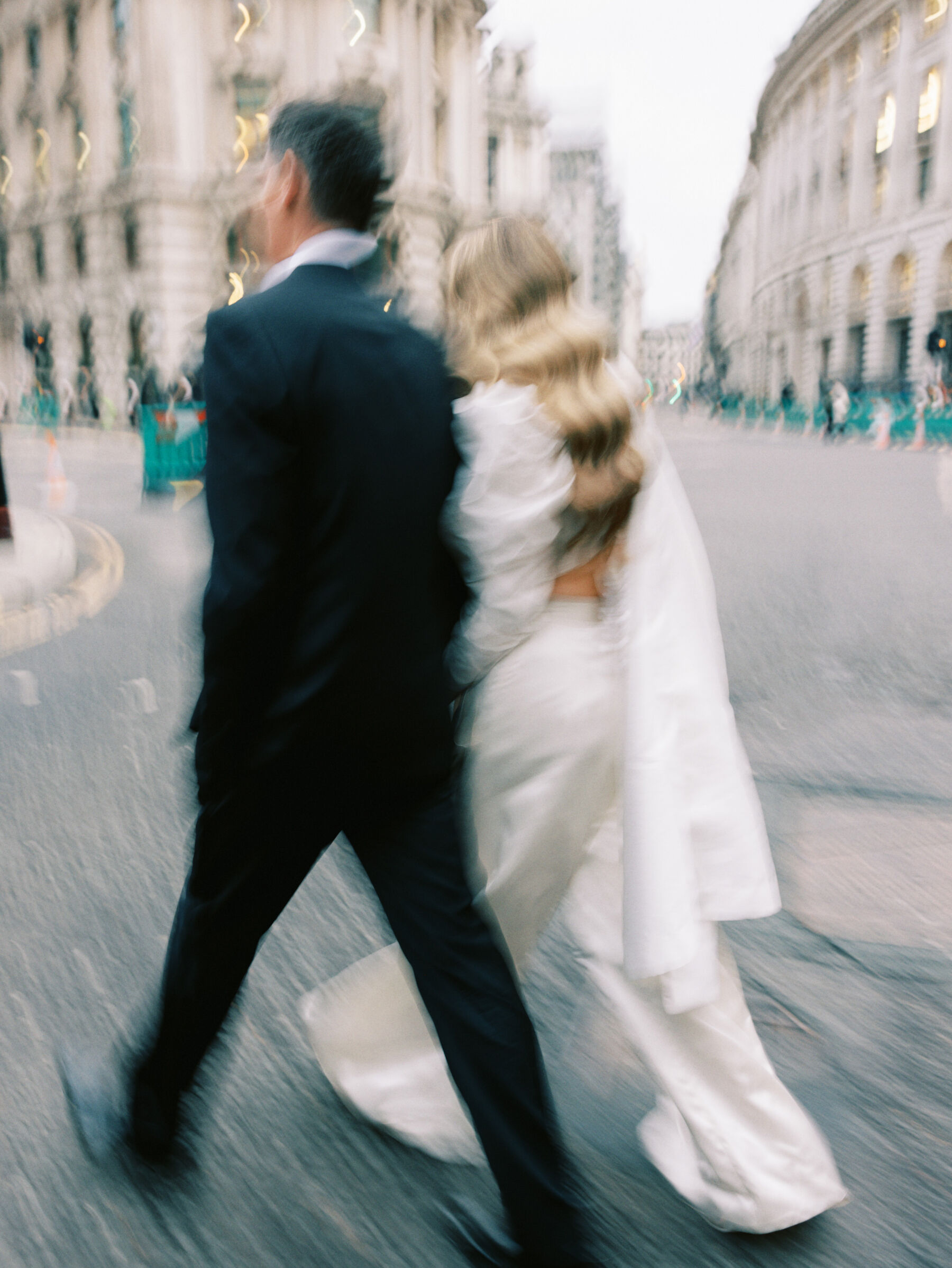 Blurred photography of bride and groom walking the streets of London. Kernwell Photography.
