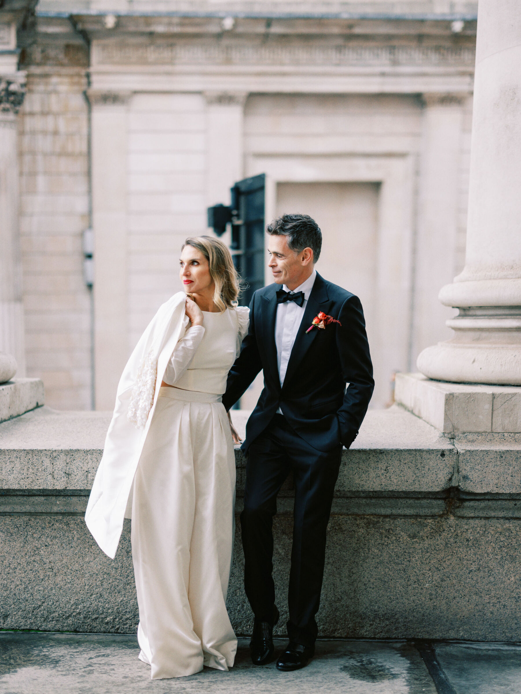 Peter Lindbergh and Dior inspired photograph of bride and groom in London. Bride wears modern wide leg bridal trousers by Halfpenny London. Kernwell Photography.