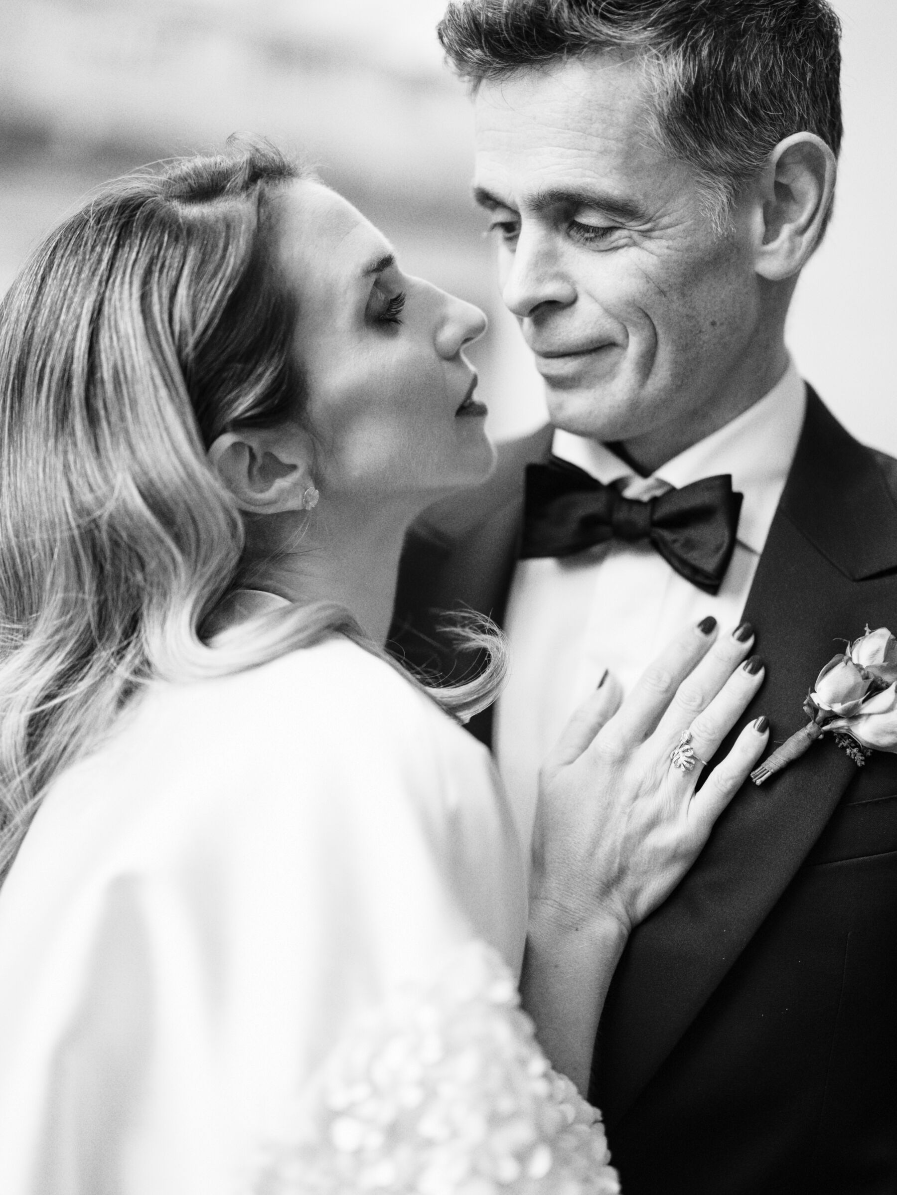 Classy black and white image of bride and groom in romantic embrace, inspired by Peter Lindbergh. Kernwell Photography.