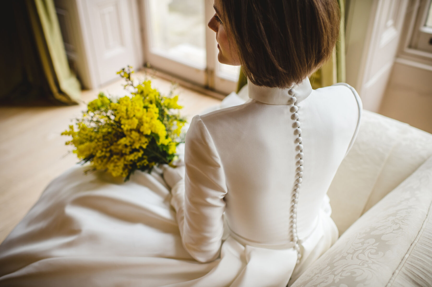 Long sleeved high neck wedding dess with row of buttons down the back, Jesus Peiro 35th anniversary dress for Miss Bush bridal boutique.