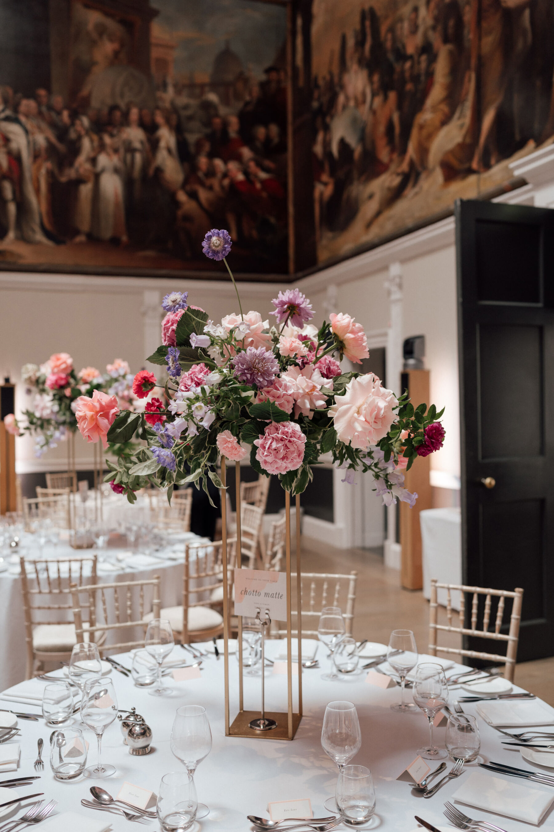 BUD Flora. Pretty pink, lilac and coral wedding flowers on tall gold table centrepiece at RSA House. The Shannons Photography