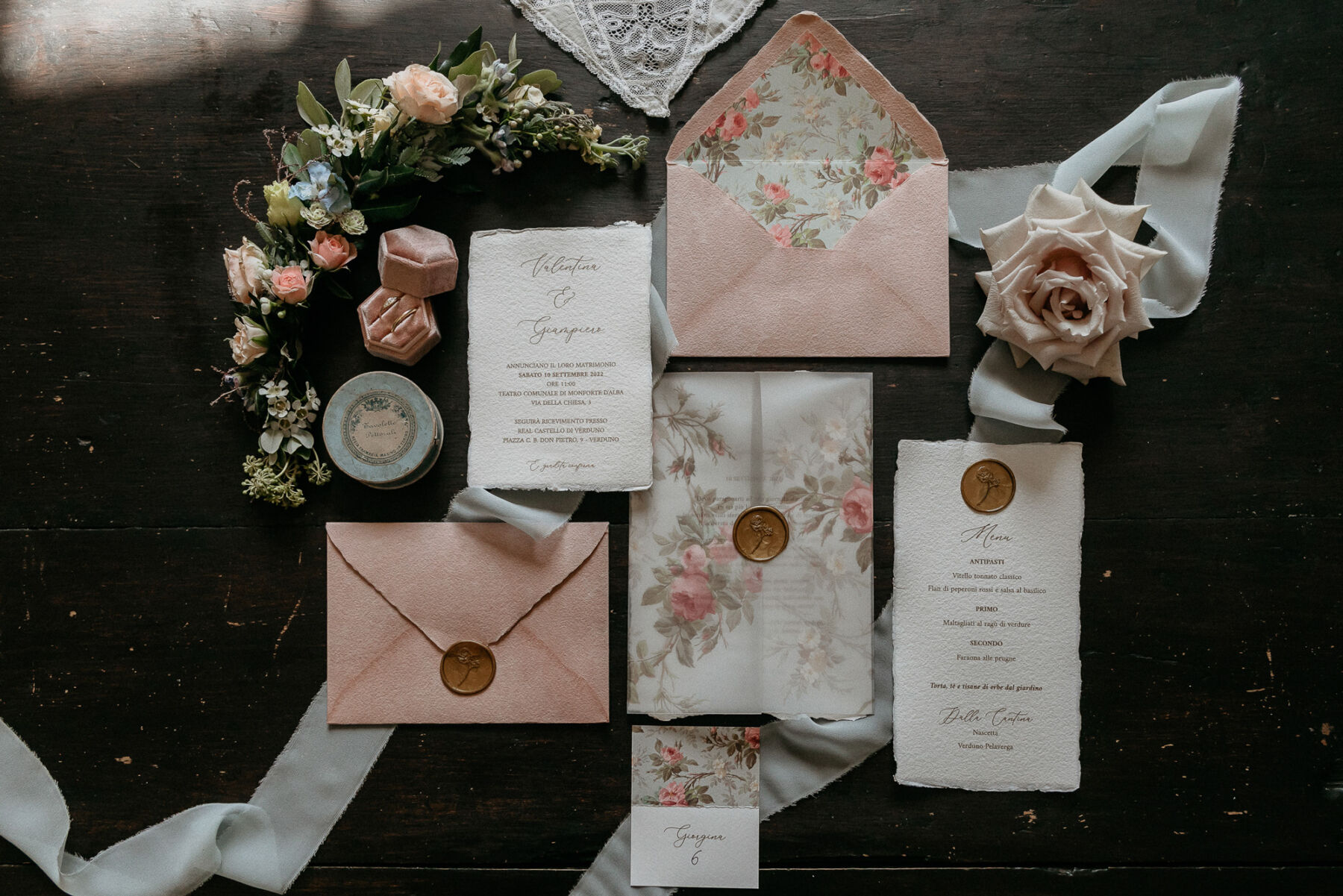 Romantic wedding stationery with floral and rose lined envelopes and gold was stamp.