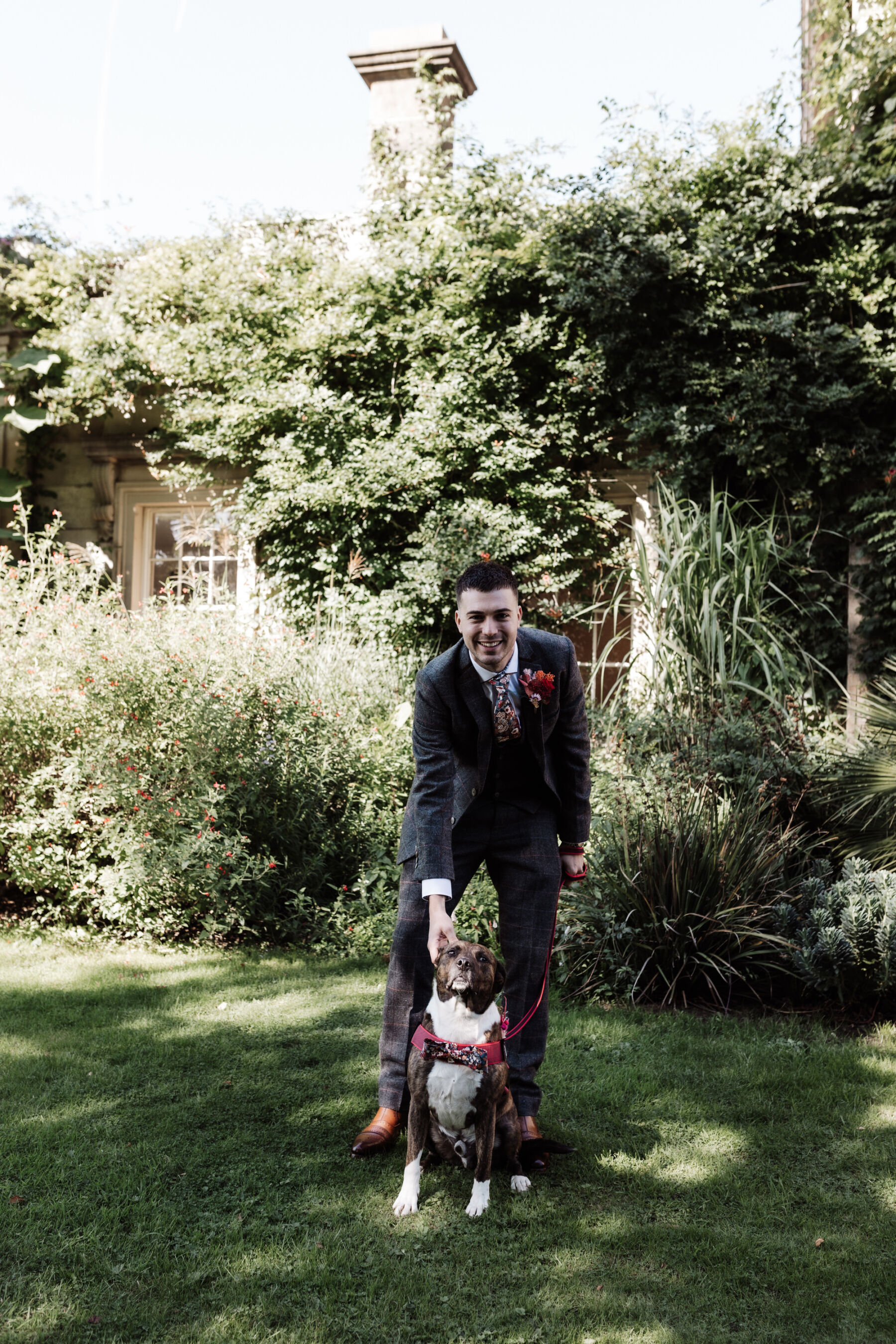 Groom with dog at wedding.