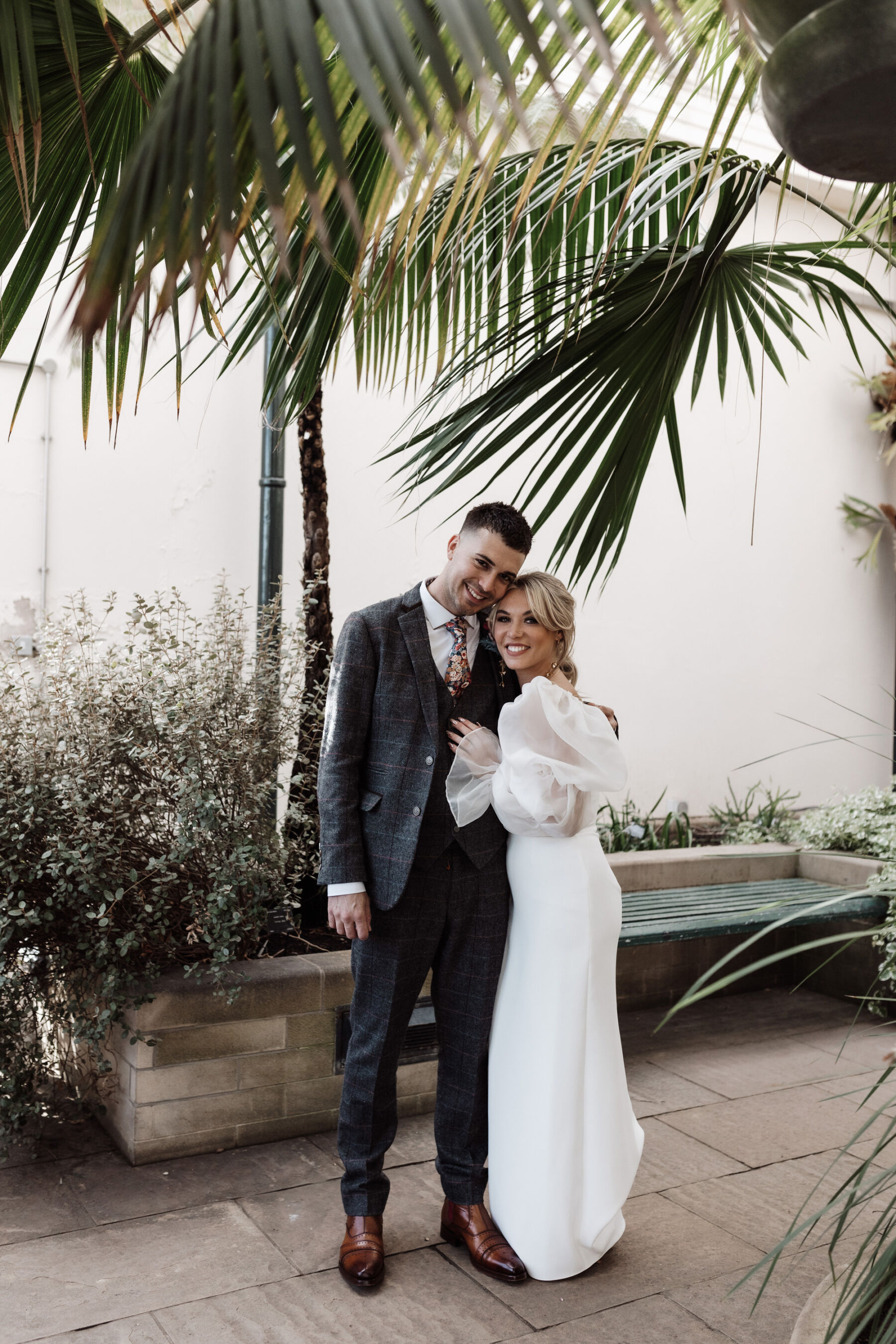 Bride and groom at Sheffield Botanical Gardens. Bride in detachable puff sleeves. Alexandria French Photography