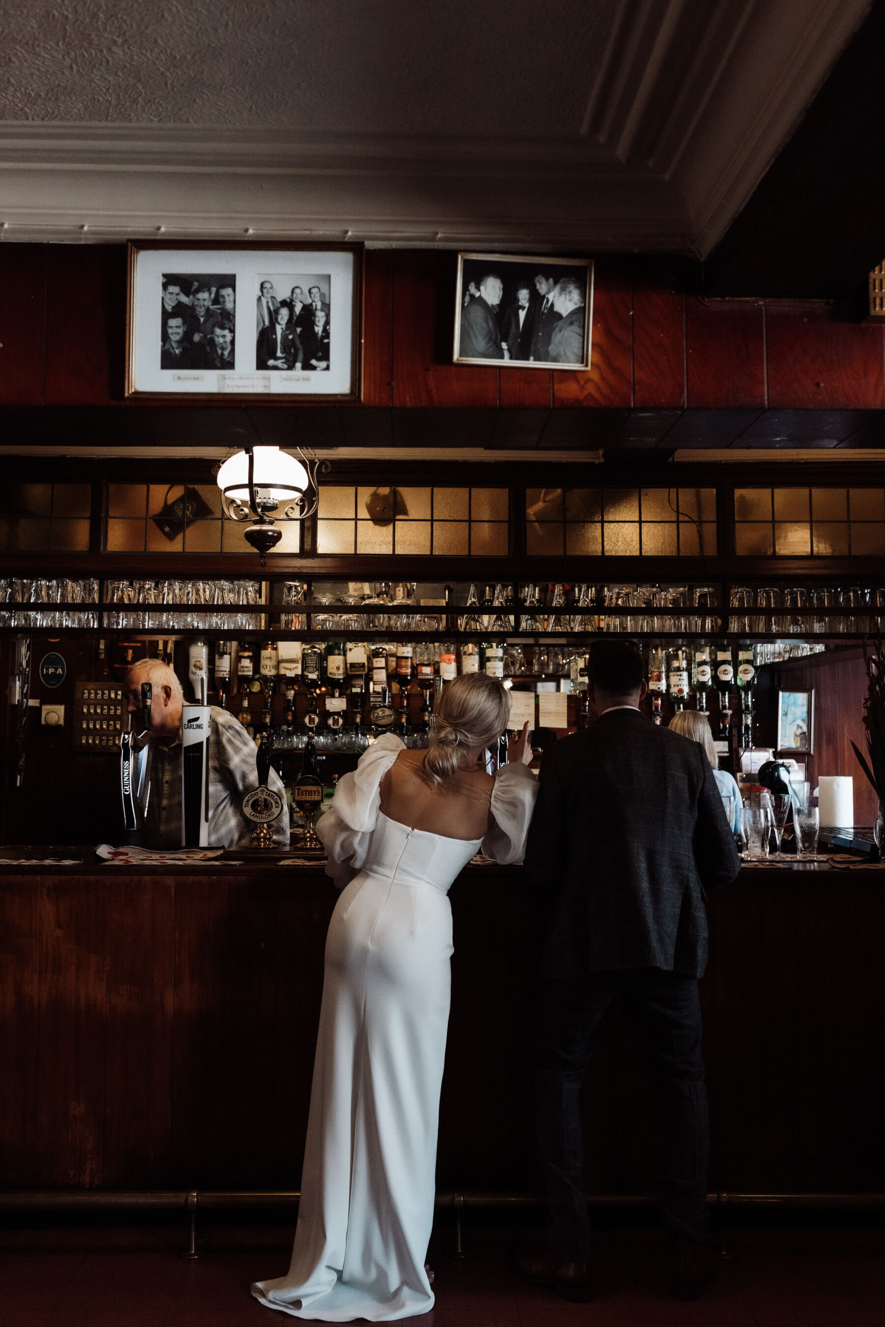 Nat, in Charlie Brear & Jesus Peiro for her Sheffield Botanical Gardens & Warehouse Party Wedding 24 Bride and groom at Fagans bar in Sheffield. Alexandria French Photography.